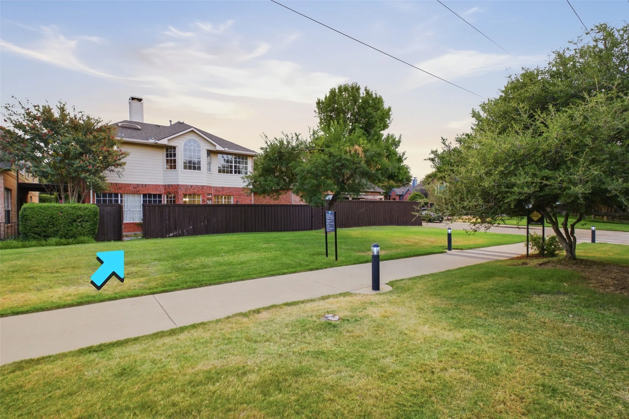 A twilight view of the property nestled in its established, tree-lined neighborhood — mature trees, manicured lawns, and a community trail greenway just steps from the front door. This is a true Addison gem in a standout location.
