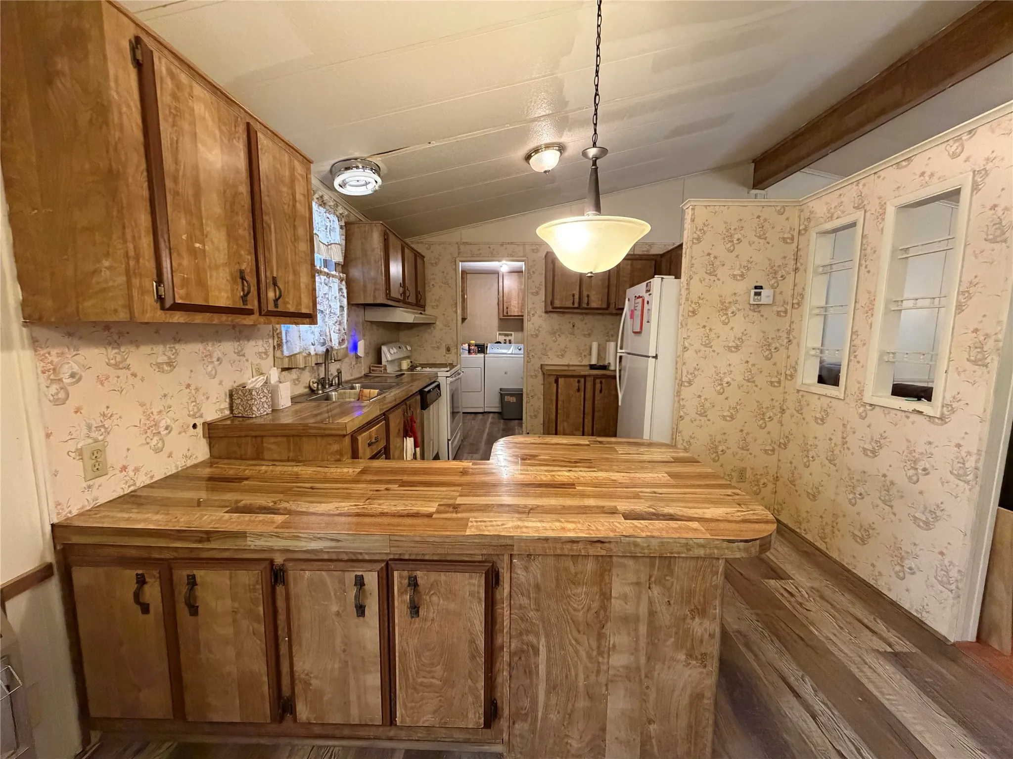 Wood-finish cabinetry paired with a matching wood-finish countertop