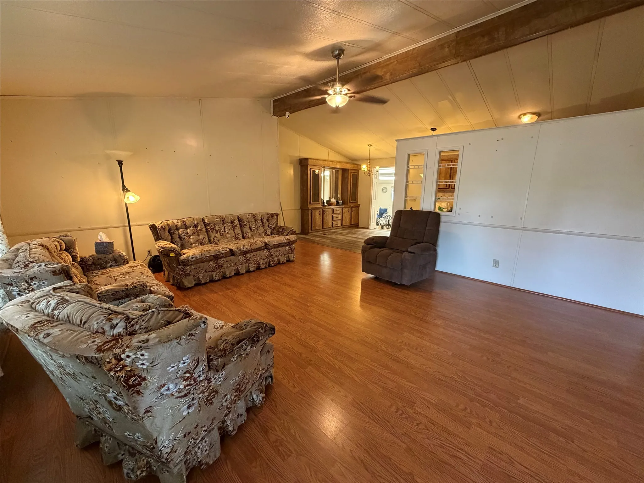 Wood-finish flooring throughout, paired with a vaulted ceiling