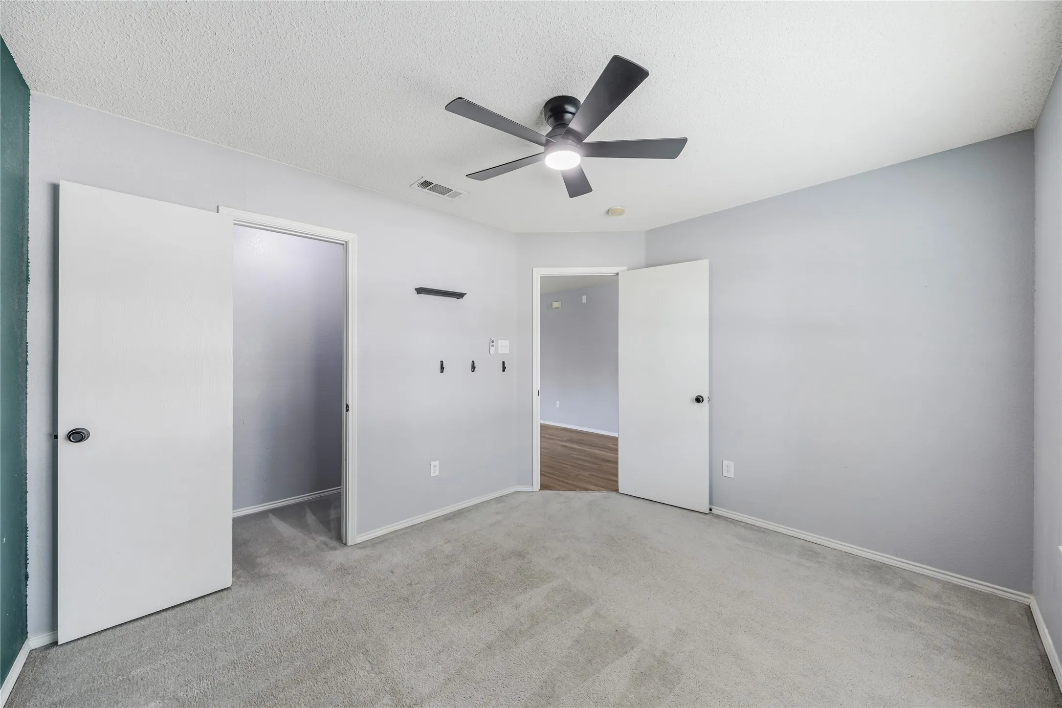 Second view of the front bedroom showing the large walk-in closet