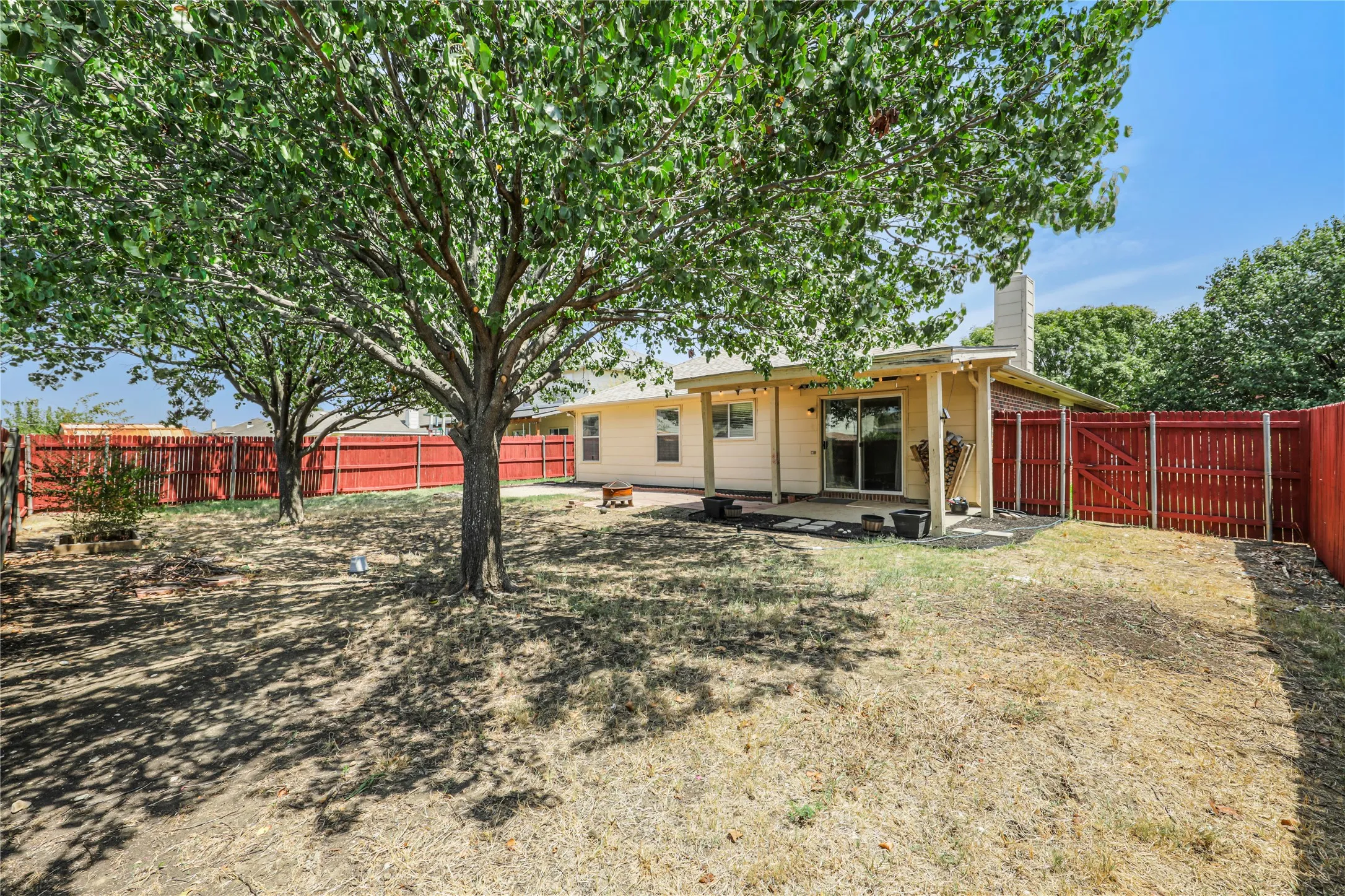 Great back yard ready for entertainment or relaxation with the extended covered back patio and beautiful shade trees.