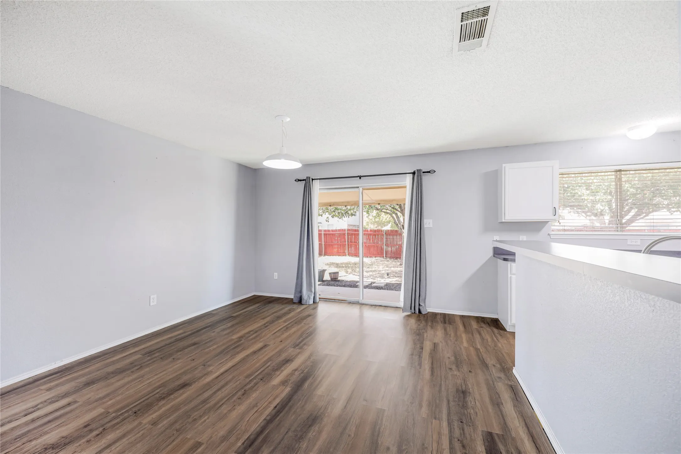 This large dining room features a sliding glass door leading to the covered patio and backyard.