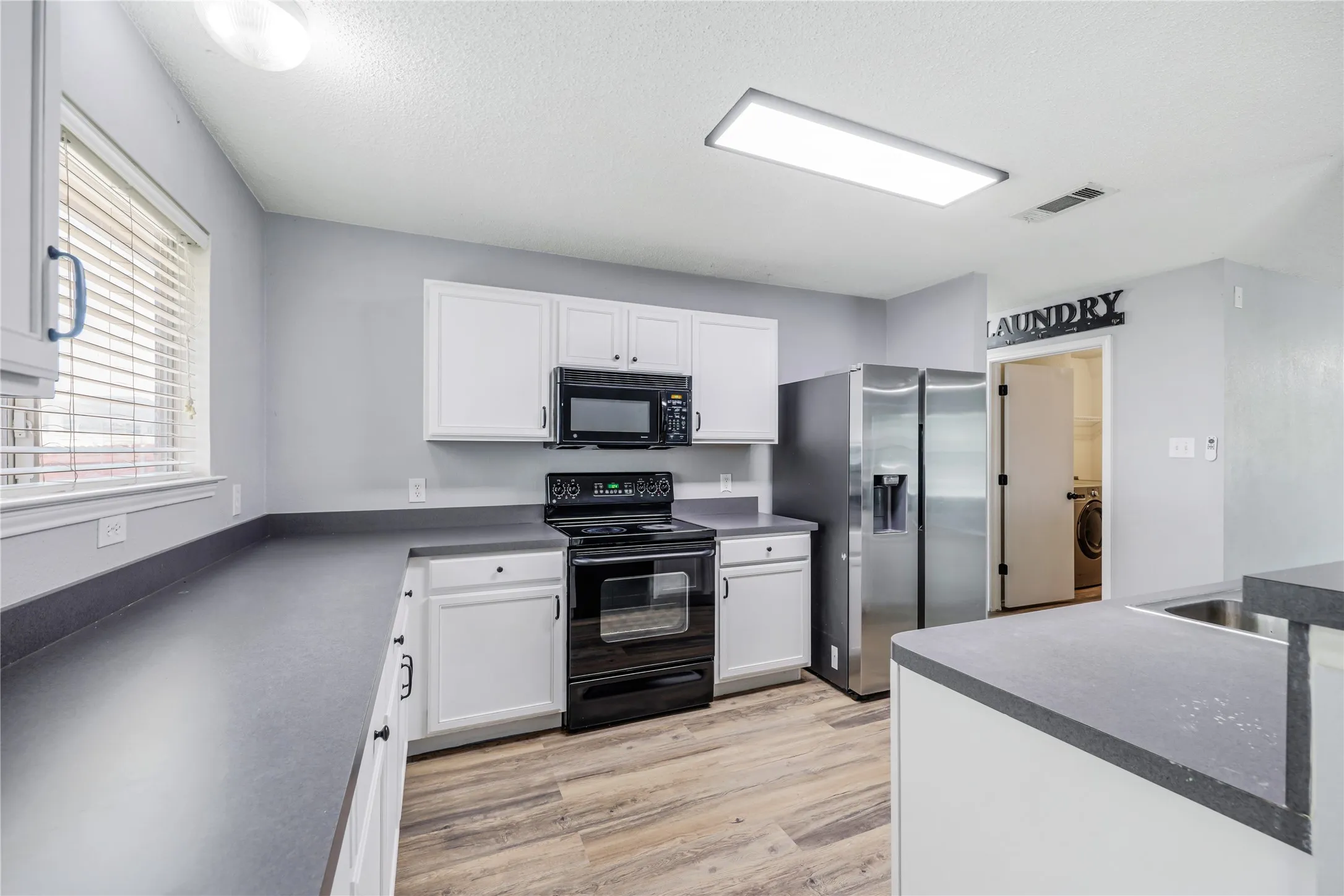 Loads of cabinets and counter space in this kitchen.