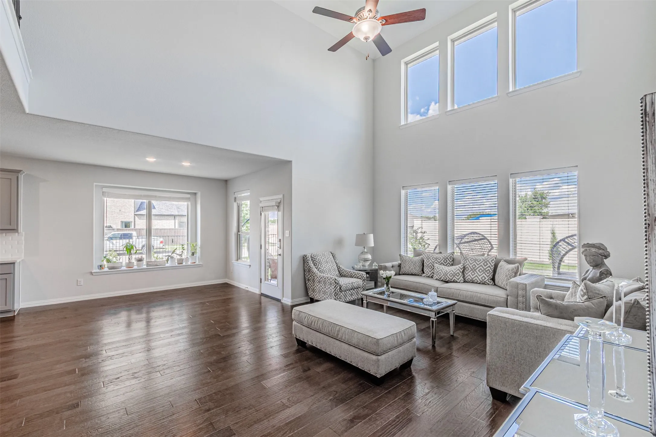 Expansive living area featuring soaring ceilings and dark wood-finish flooring