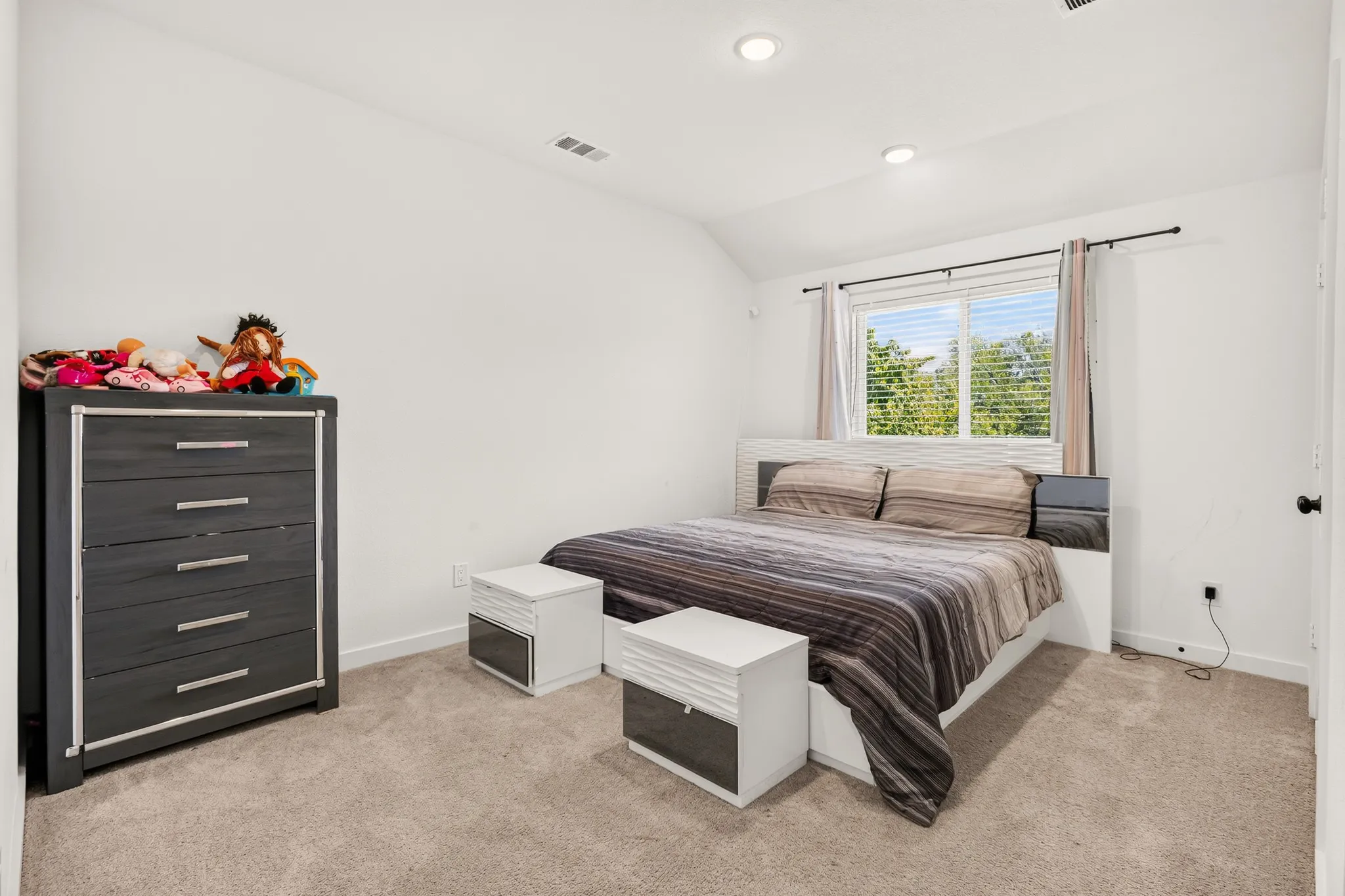 Plush carpet flooring, recessed lighting, and a window with blinds
