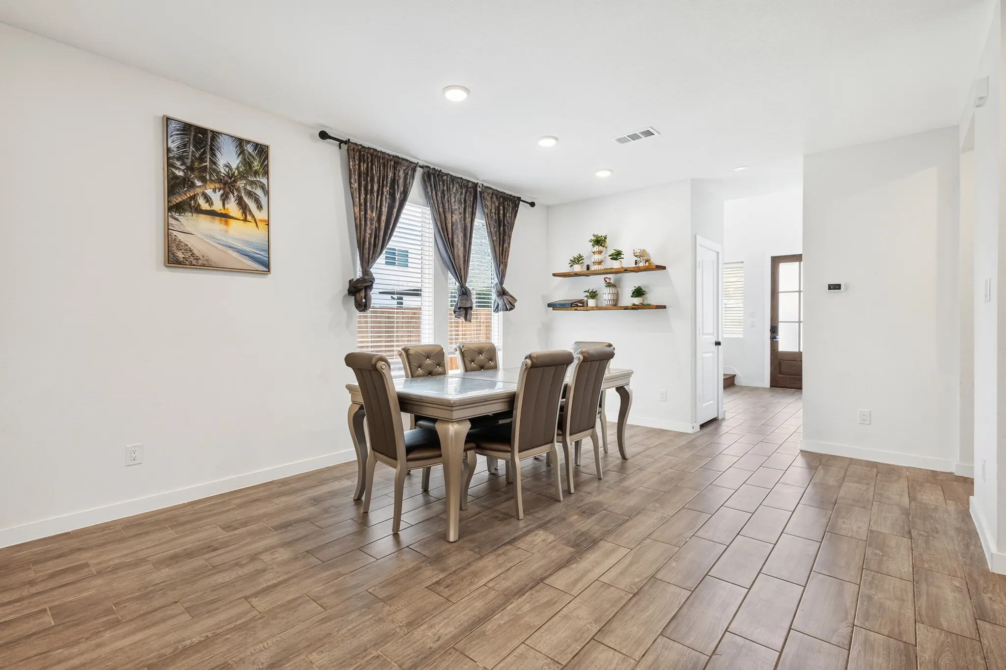 Wood-finish tile flooring throughout, recessed lighting, and a window with blinds