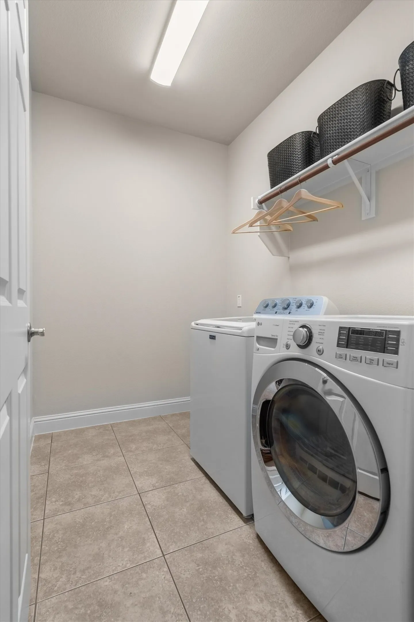 Convenient laundry room with washer and dryer included, plus shelf storage