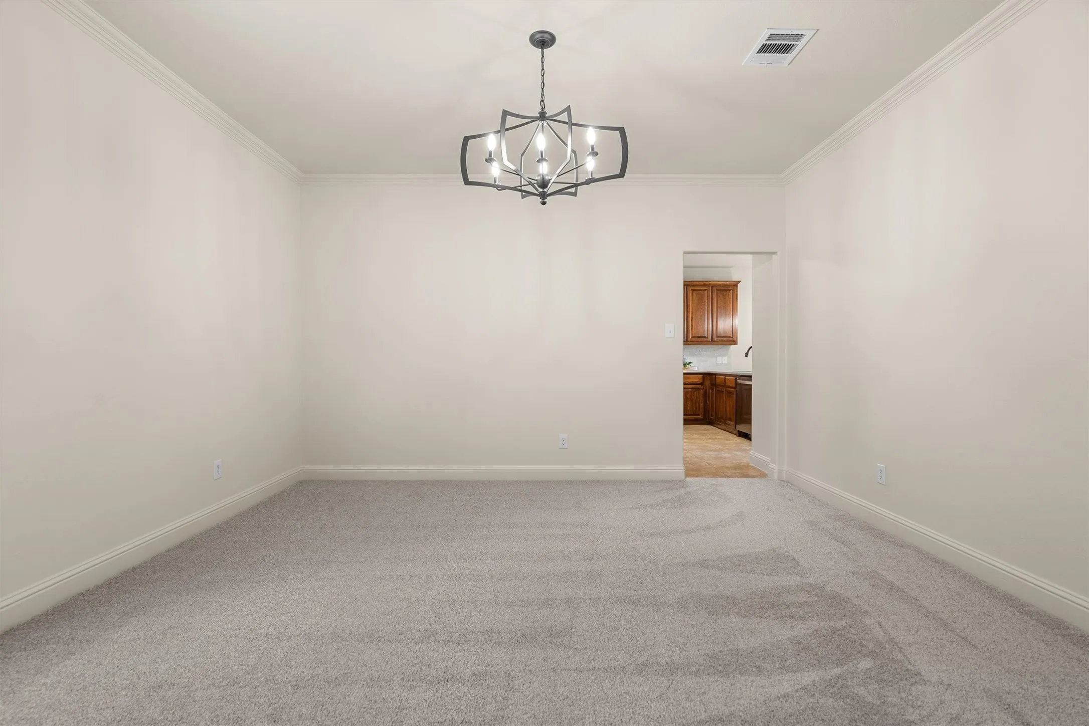 Open flex space with chandelier, ready for your personal touch