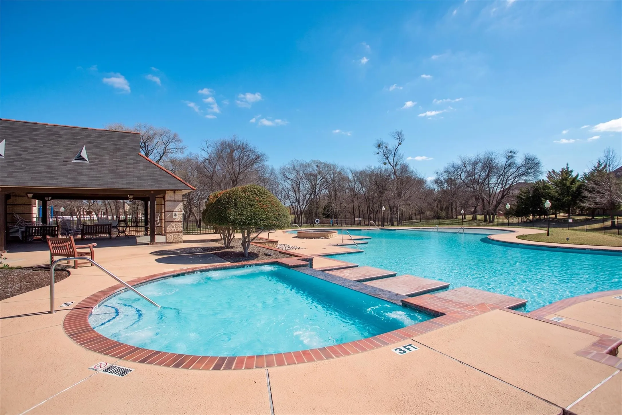 Resort-style community pool with covered pavilion and lounge area