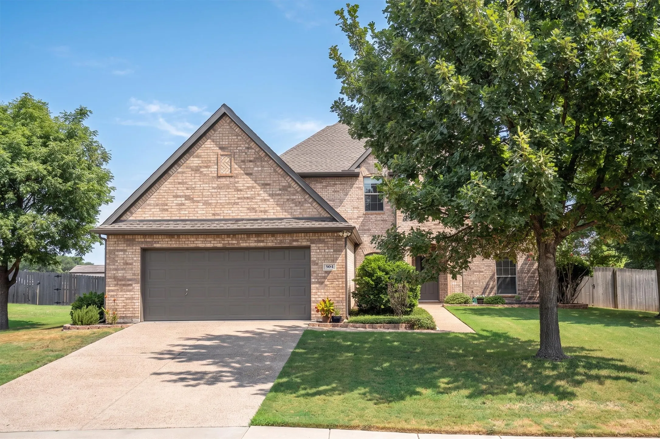 Front exterior view highlighting brick facade and attached garage