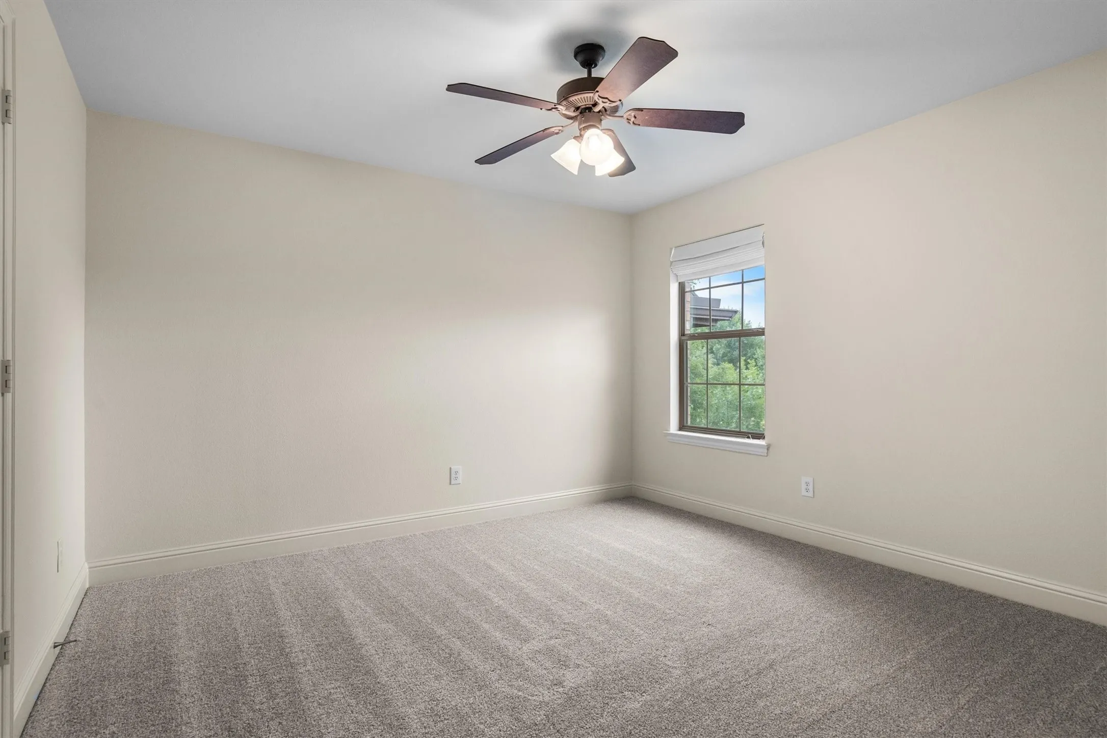 Additional secondary bedroom with ceiling fan and window