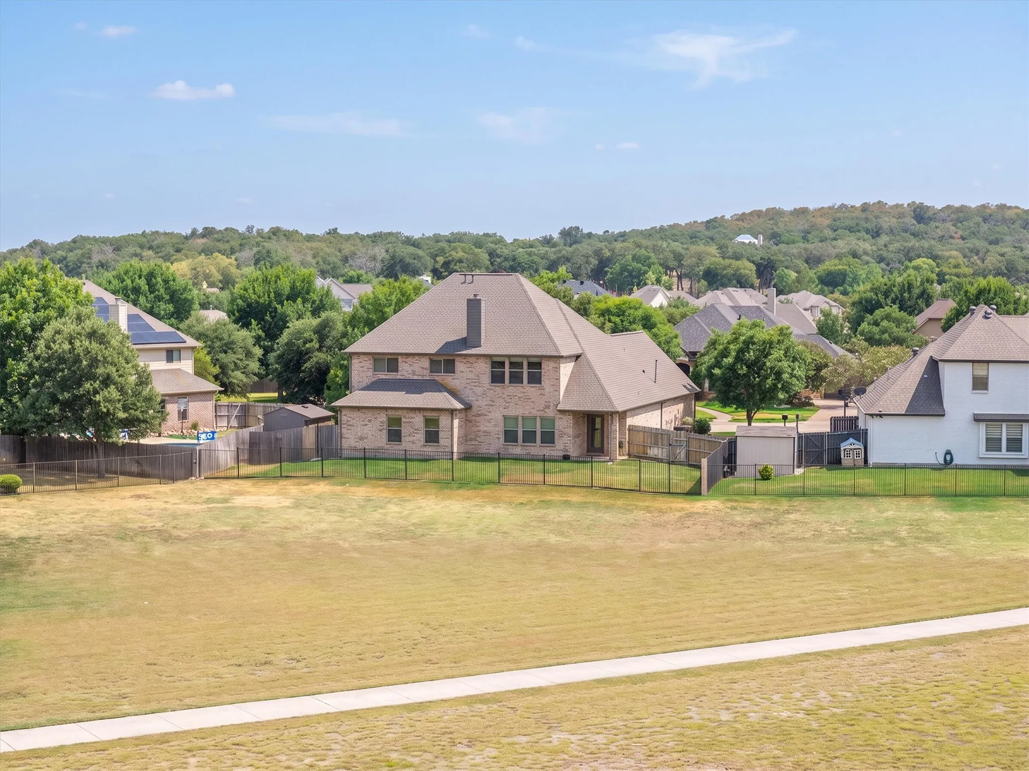 Aerial view of the backyard framed by adjacent open land
