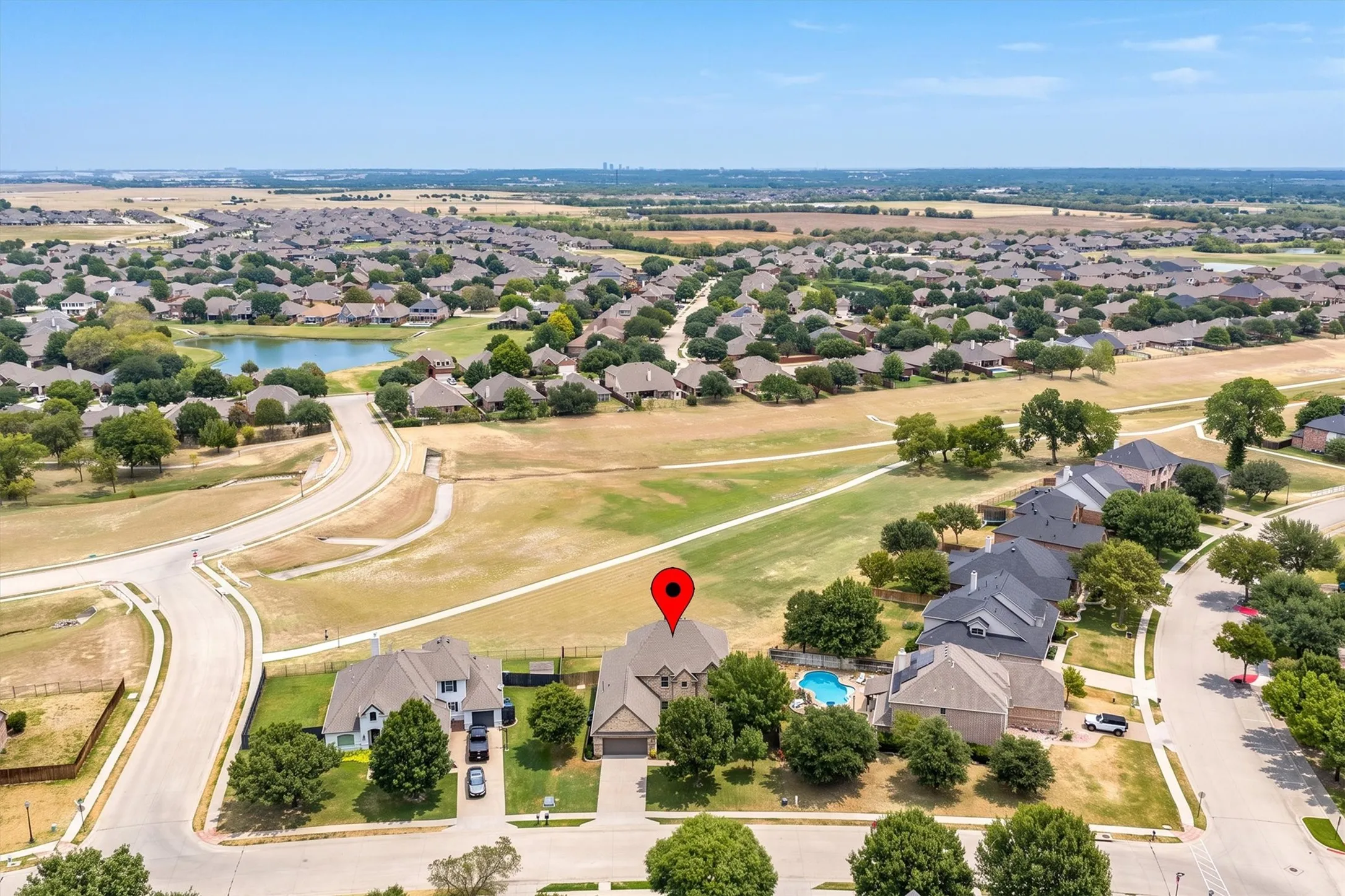 Aerial neighborhood view highlighting the community pool and prime lot location