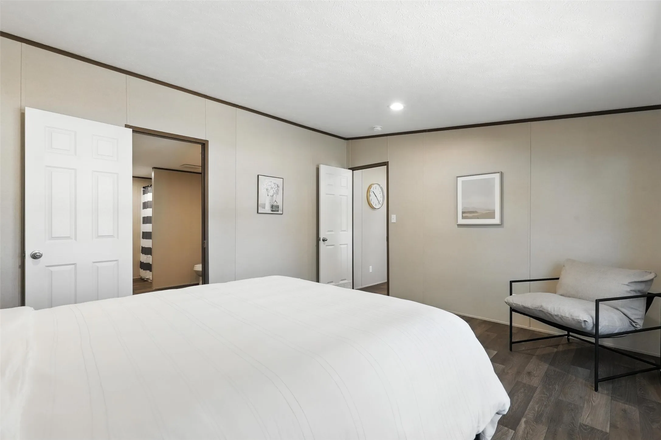 Wood-finish flooring with neutral wall tones and dark trim