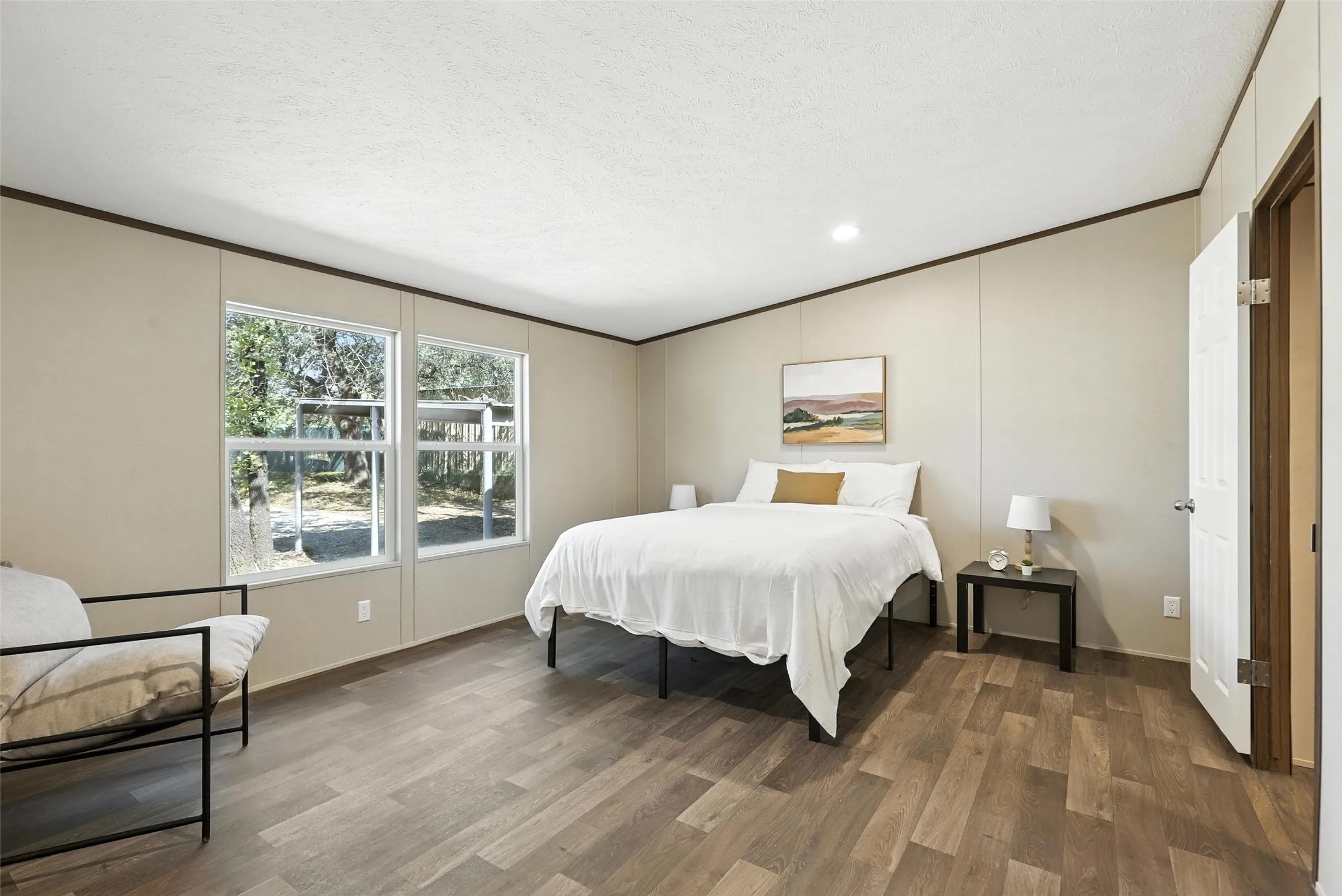 Wood-finish flooring, recessed lighting, and dual windows