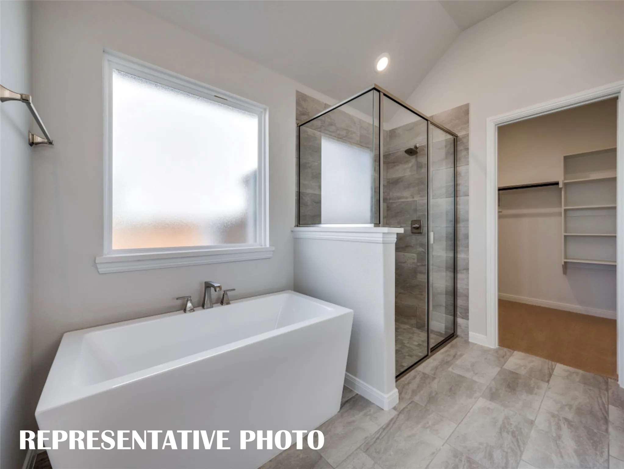 Ample closet space, a spacious walk in shower, freestanding tub....this dream owner's bath has it all!  REPRESENTATIVE PHOTO