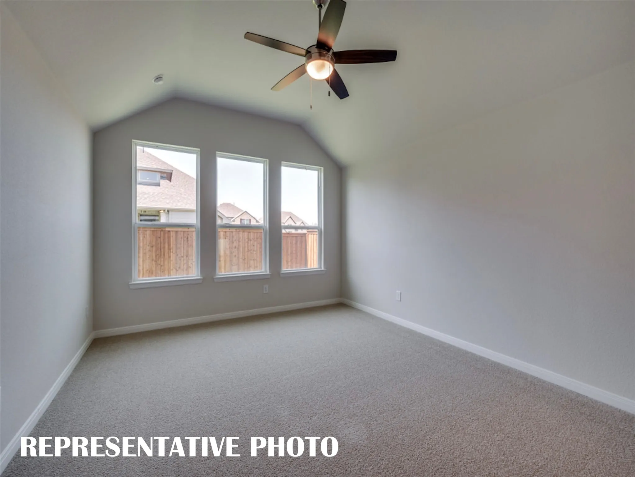 A wall of windows provides a peaceful and relaxing back yard view in this owner's suite.  REPRESENTATIVE PHOTO
