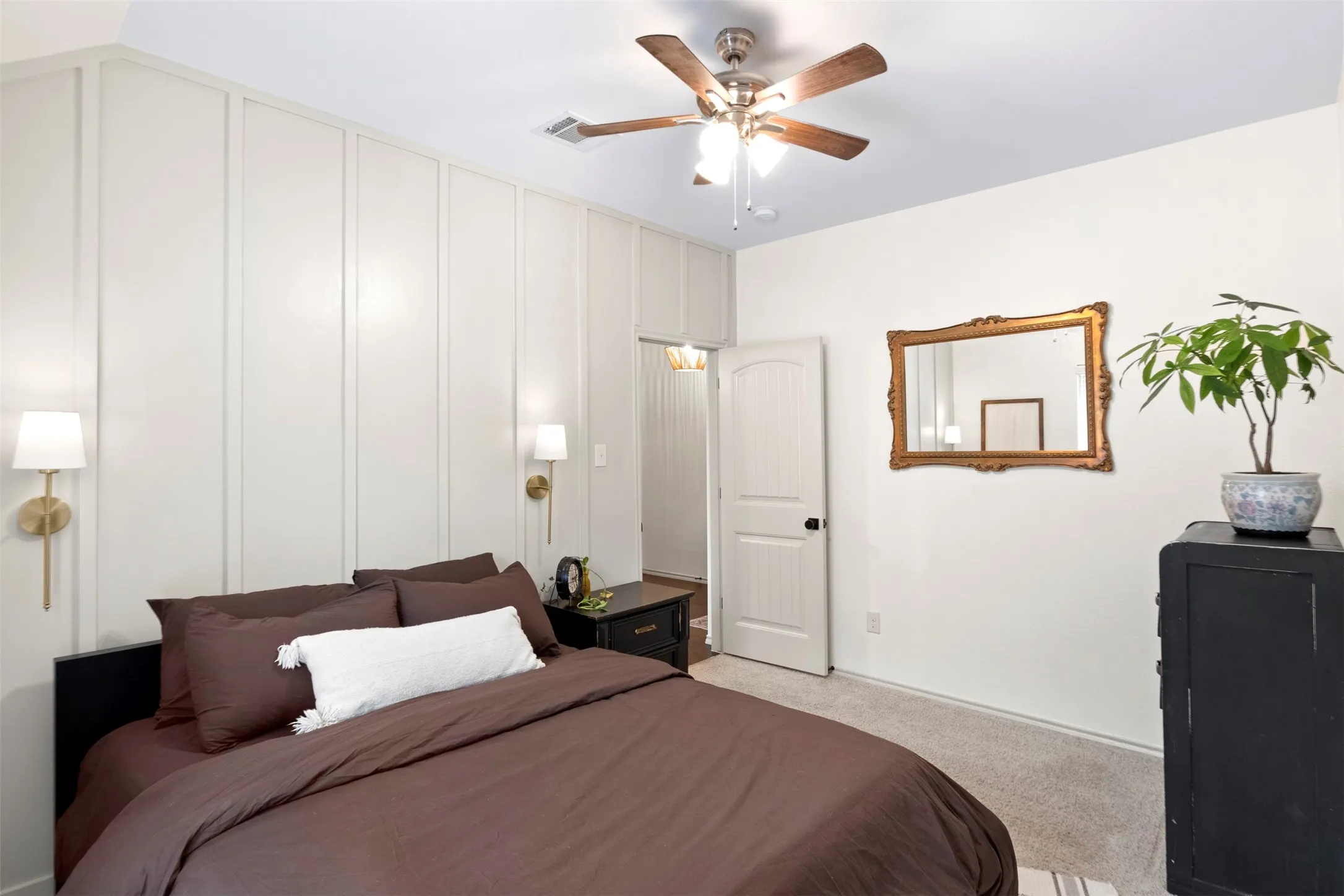 Another angle shows the bedroom’s comfortable proportions and added architectural detail along the accent wall.