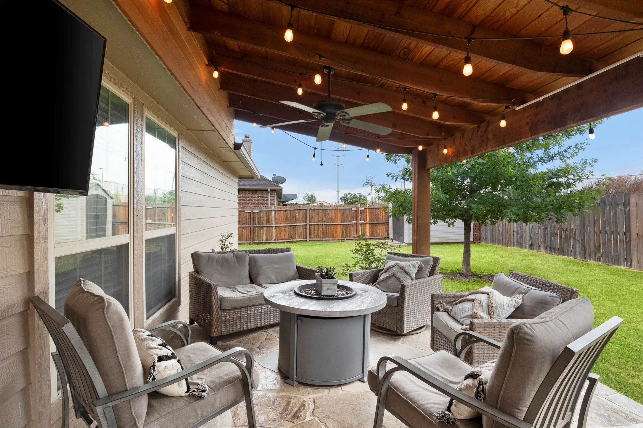 Extended covered patio creates a spacious outdoor living area with room for multiple seating areas.