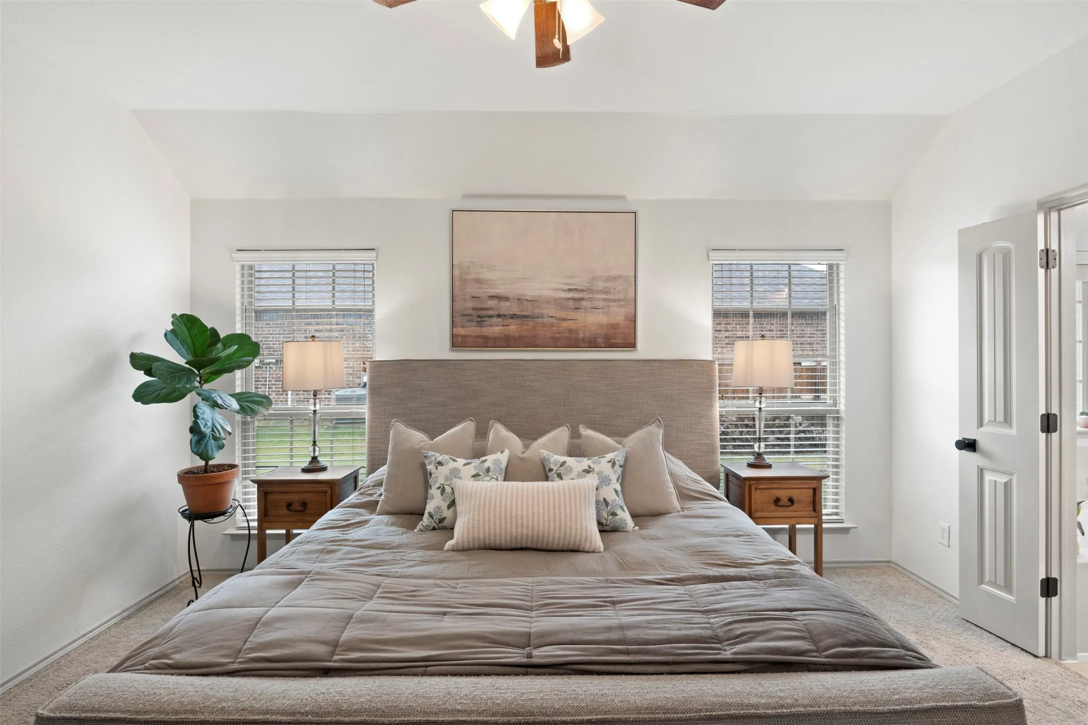 The primary suite connects directly to its private bath while still providing ample wall space and flexibility for additional furniture.