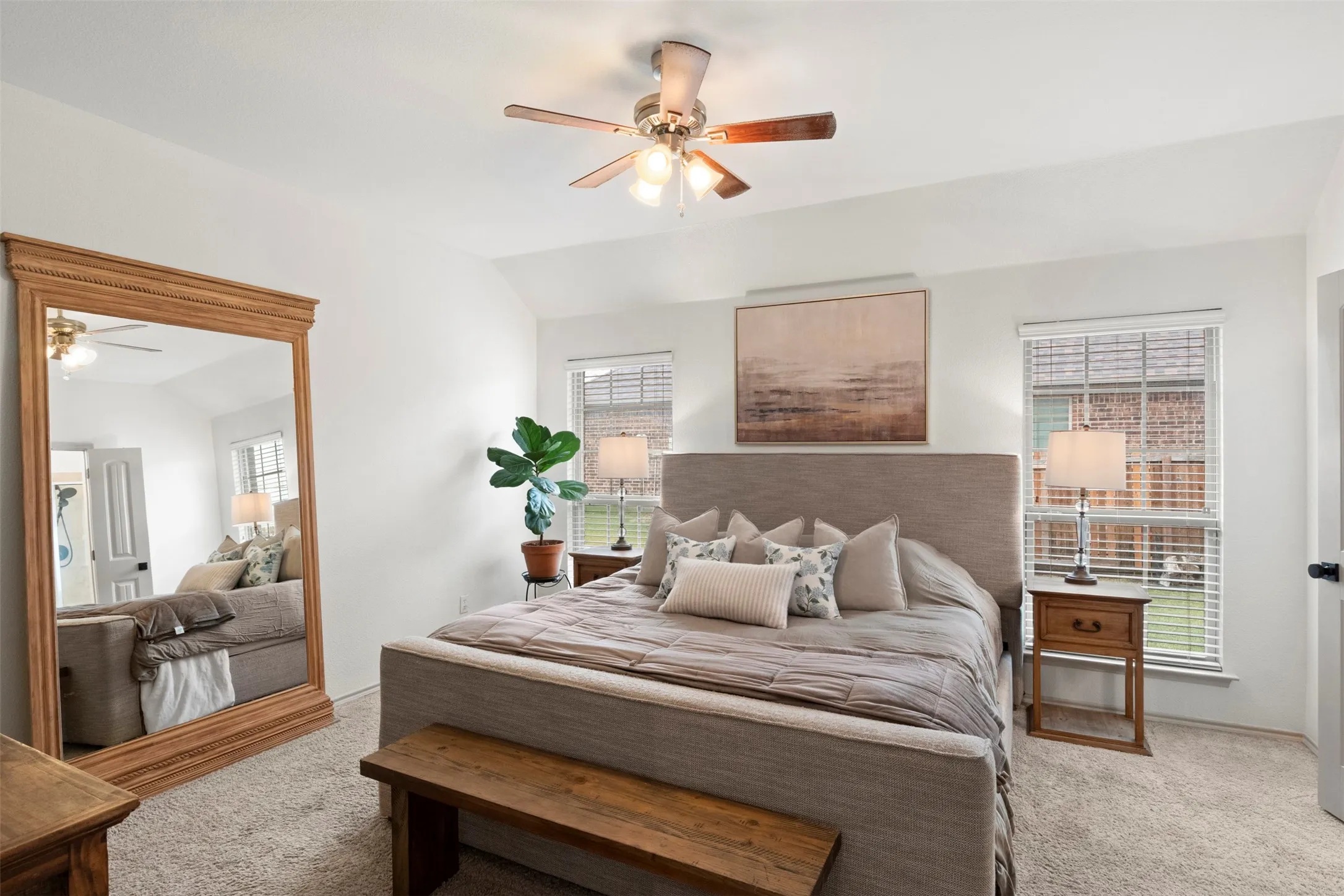 The spacious primary bedroom offers a calm, neutral retreat with fresh paint, abundant natural light and direct access to the ensuite bath.