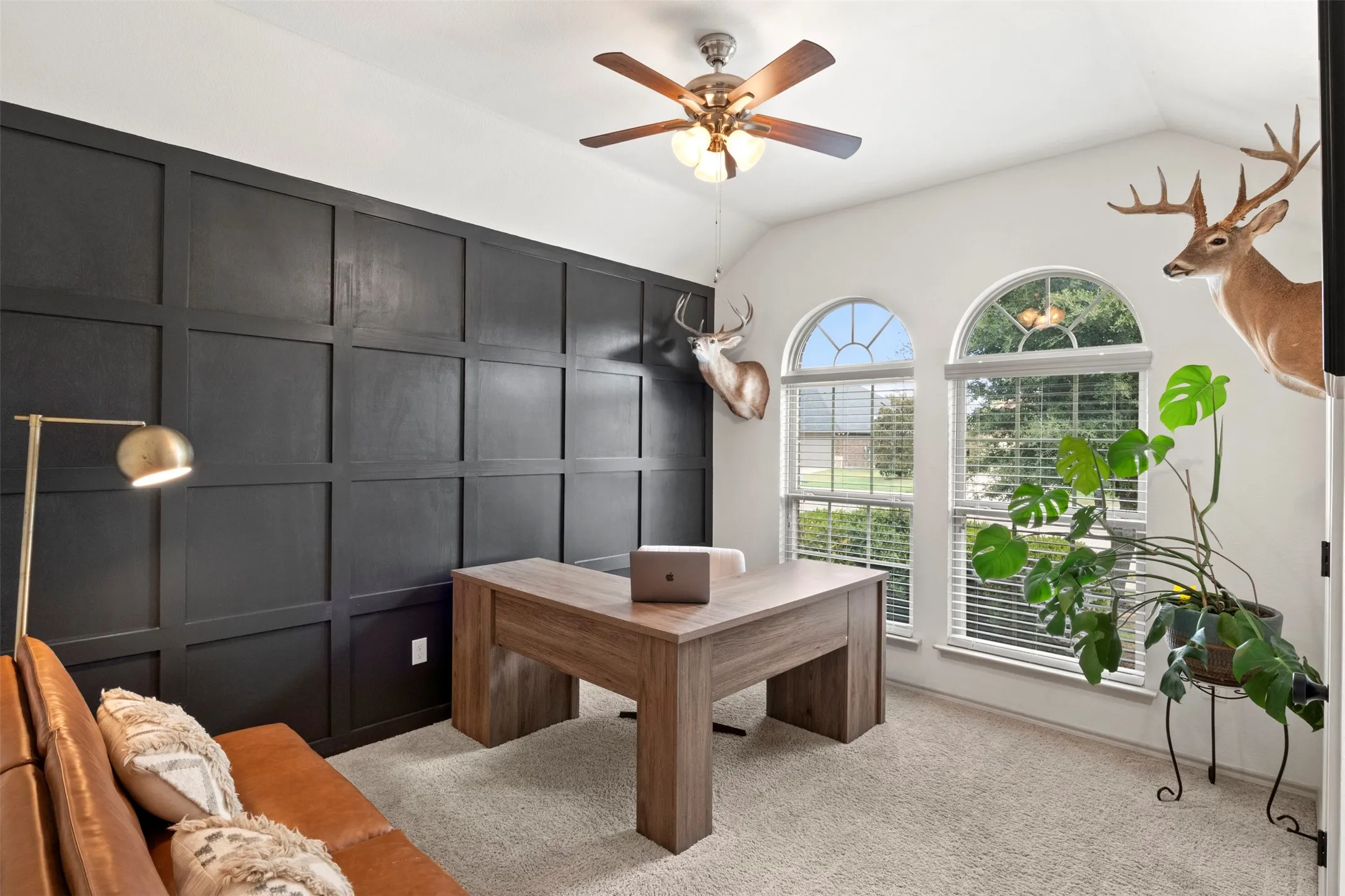 Currently styled as a home office, the third bedroom stands out with a bold accent wall, vaulted ceiling and abundant natural light.