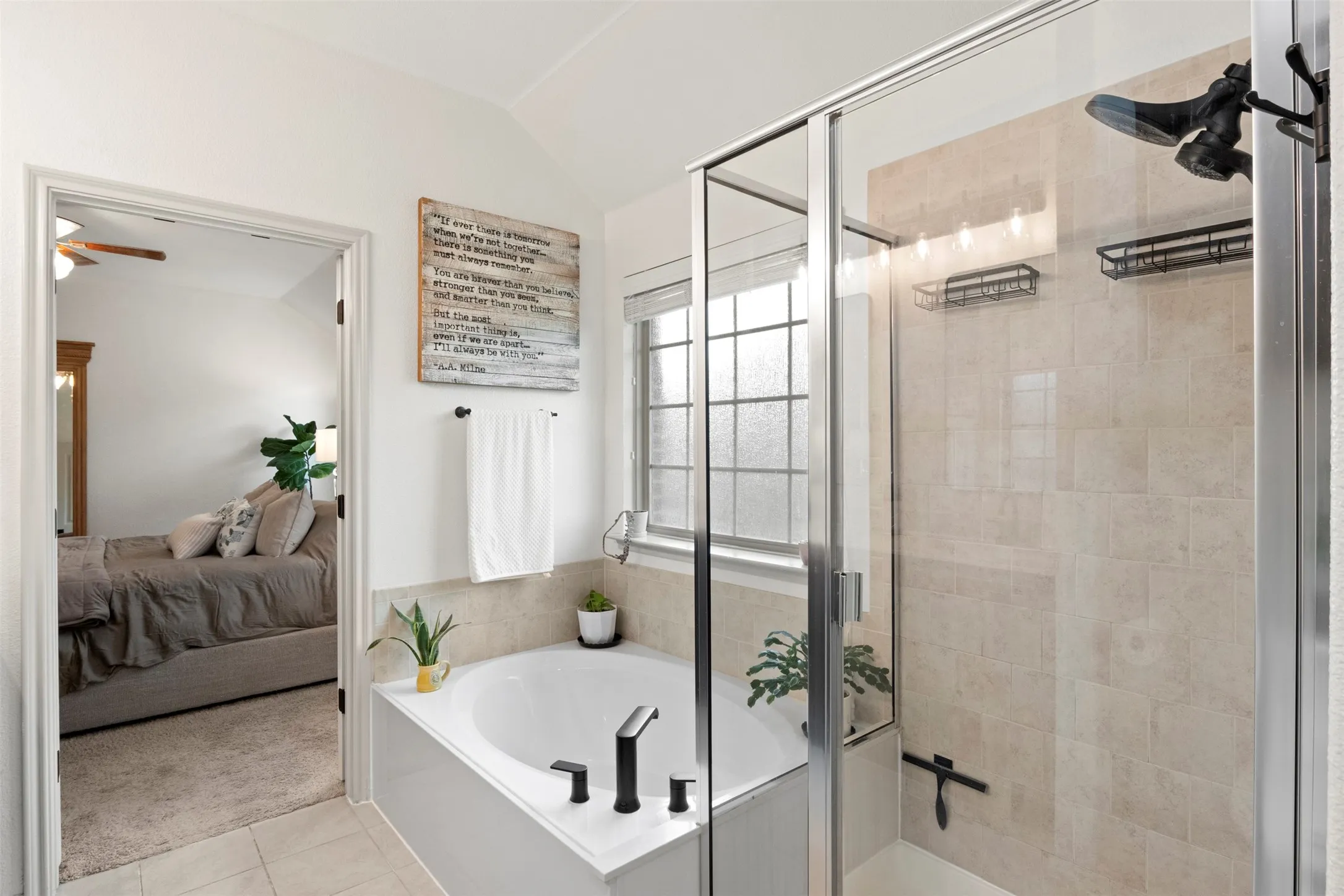 No need to choose between a tub and shower—the primary bath includes both a separate soaking tub and enclosed shower, with updated black plumbing fixtures adding a modern finish.