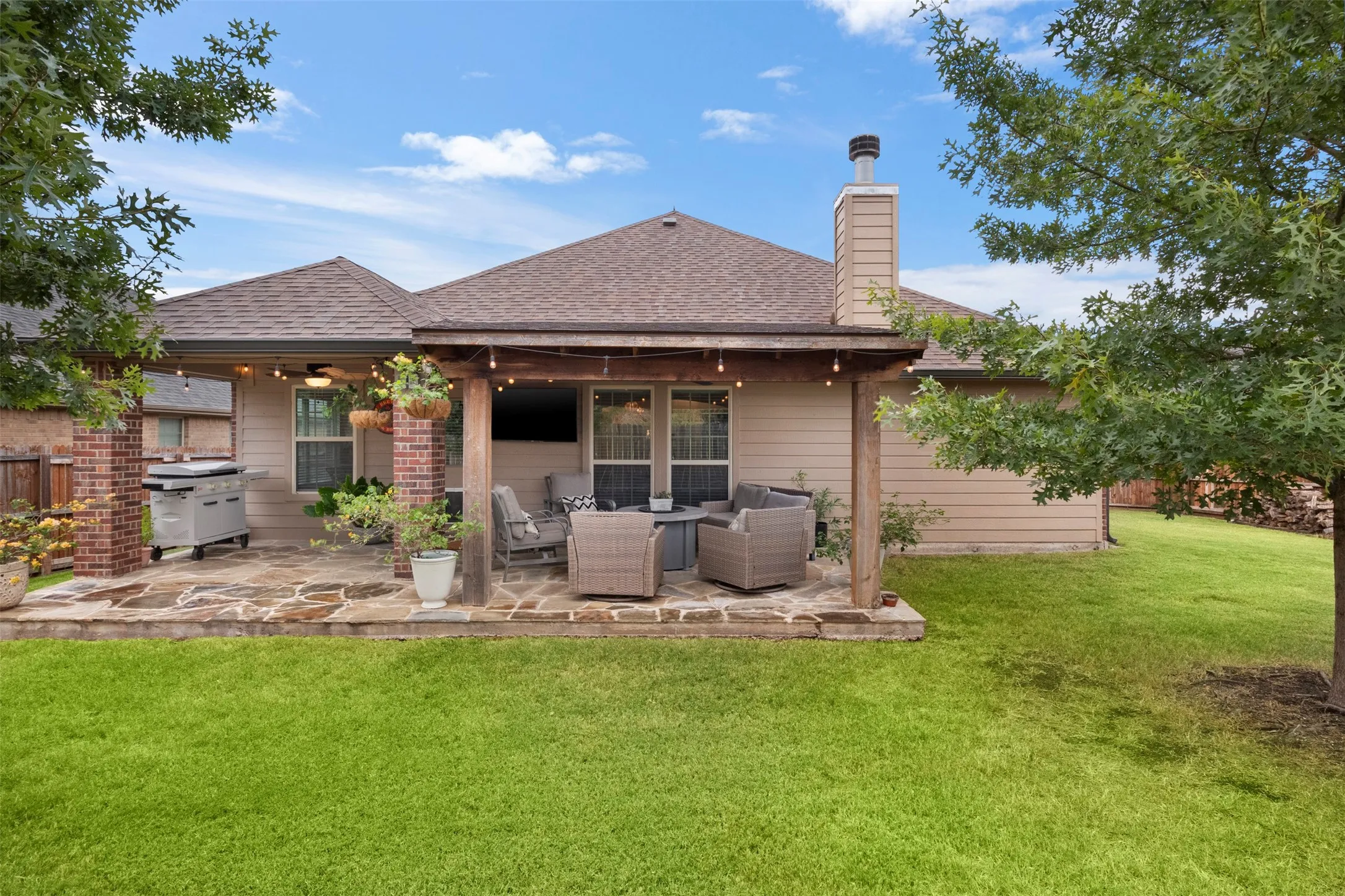 Large fenced backyard with mature trees and plenty of open lawn.