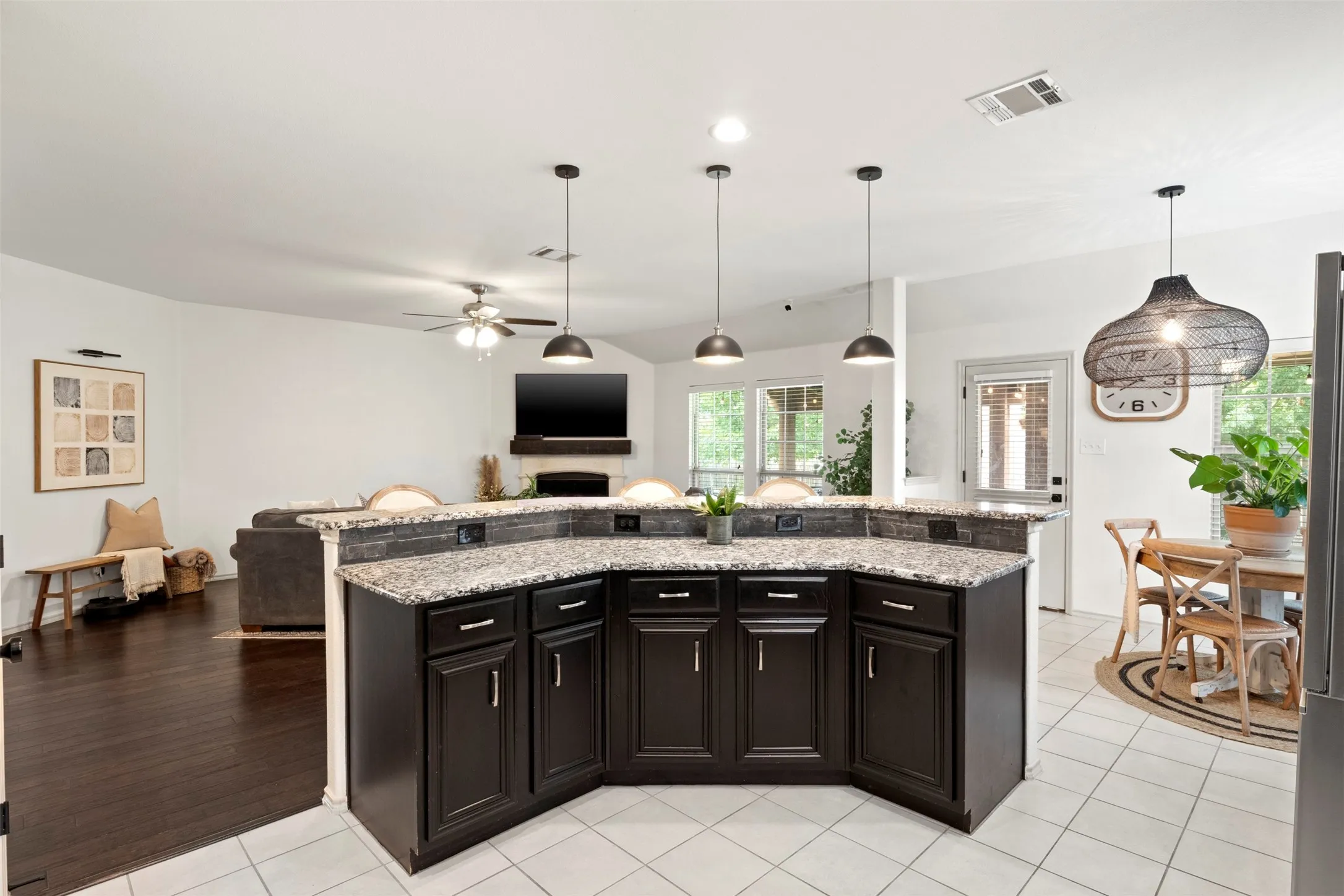 This view really shows the OPEN-CONCEPT LAYOUT—the large wraparound counter connects the kitchen to the living area while providing generous prep space and additional seating