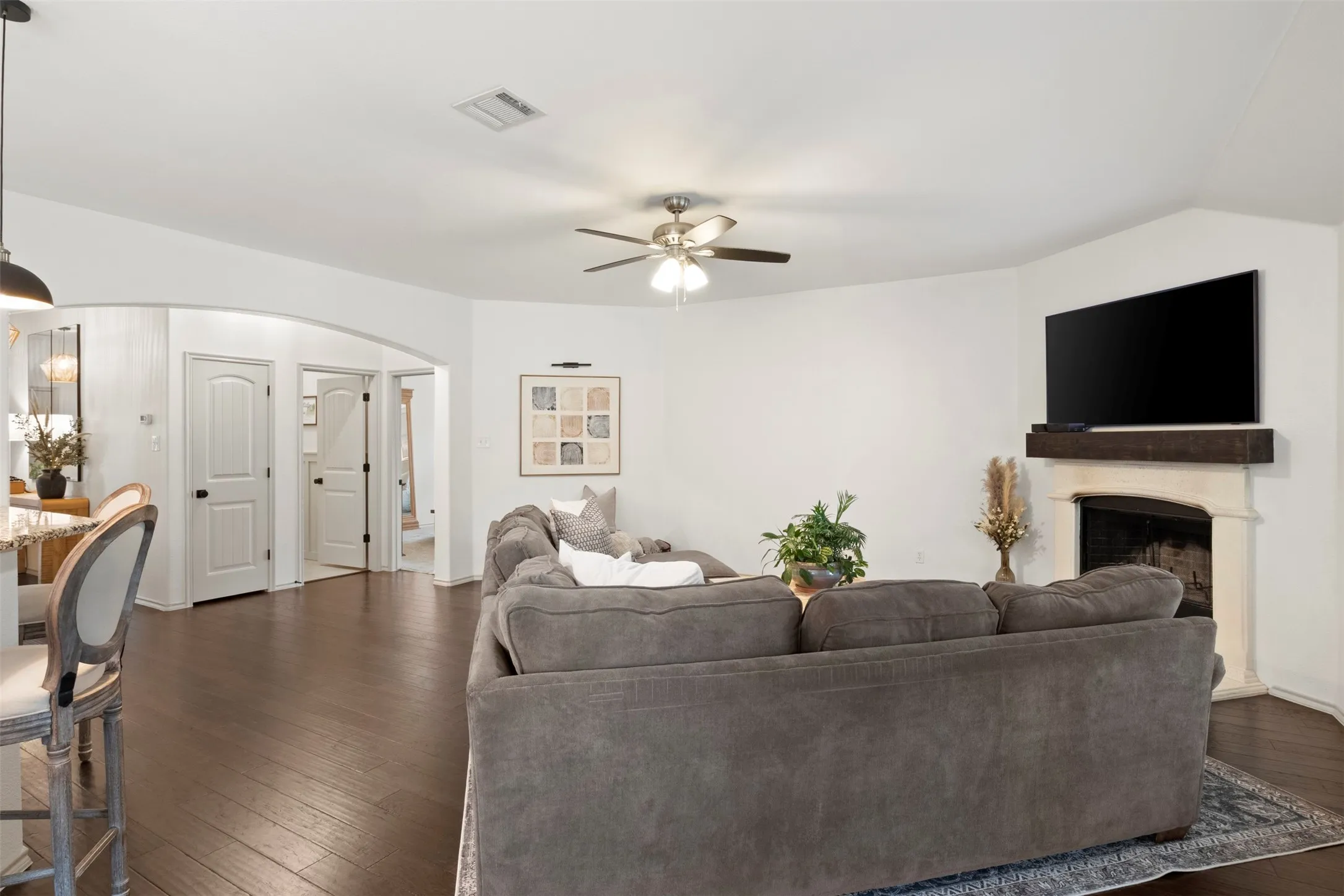 The wood-burning fireplace, generous seating area and backyard-facing windows create an inviting main living space