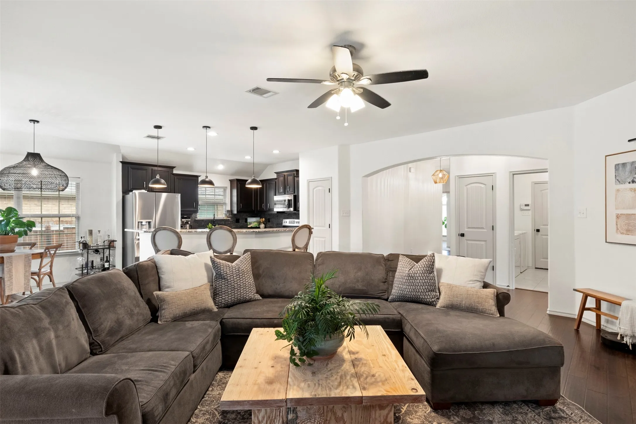 The living room flows directly into the kitchen and breakfast area, creating one connected space for everyday living and entertaining.