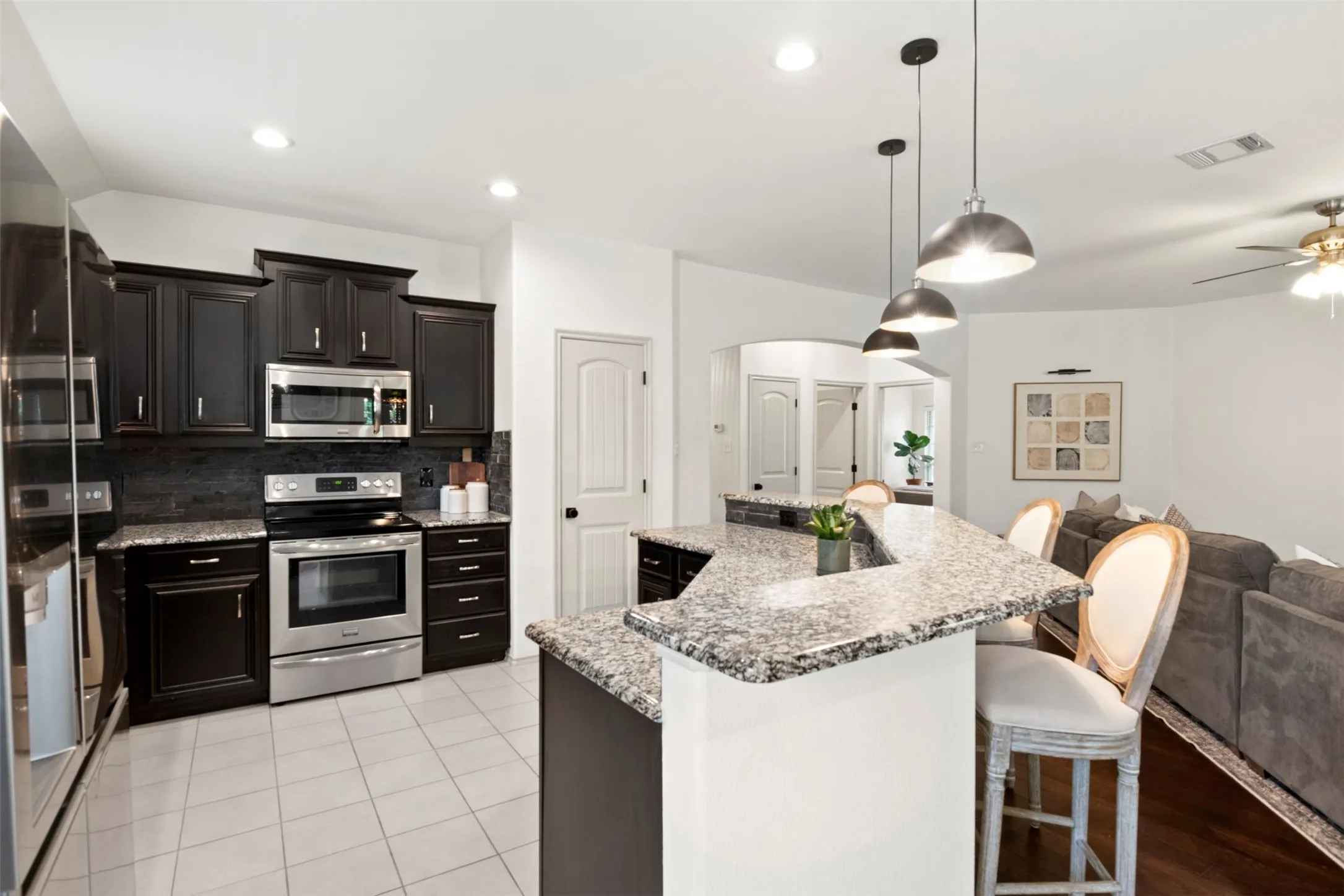 The extended breakfast bar provides seating for three while keeping the kitchen open to the main living area—ideal for everyday meals and entertaining.