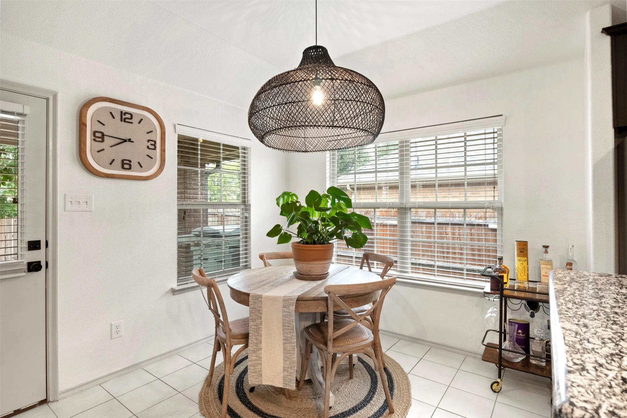 The breakfast area is surrounded by windows and sits just off the kitchen and easy access to the covered back porch.