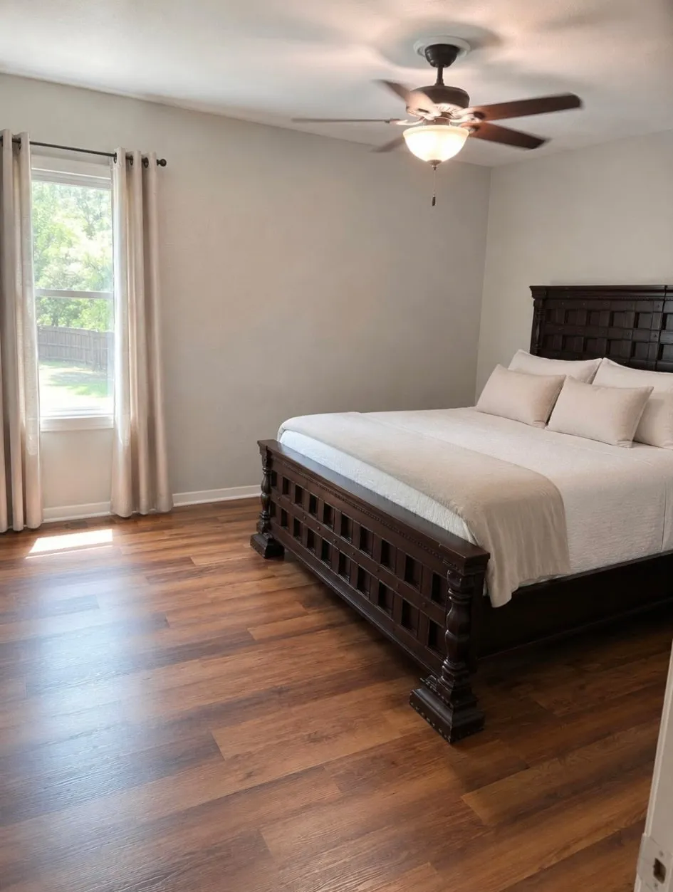Light wood-finish flooring with a ceiling fan and overhead lighting