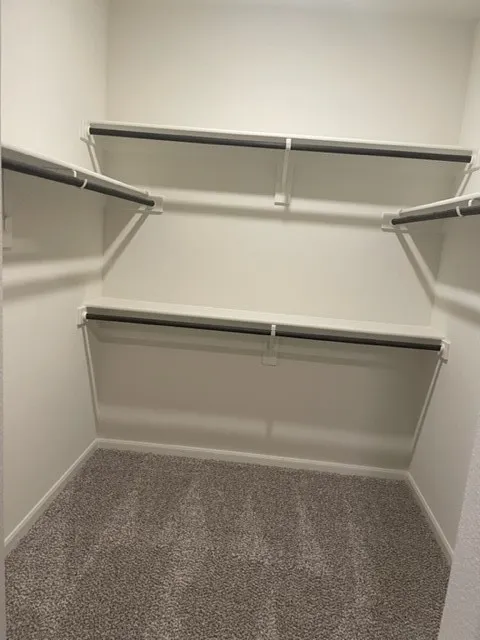 Built-in closet system with shelving and hanging rods