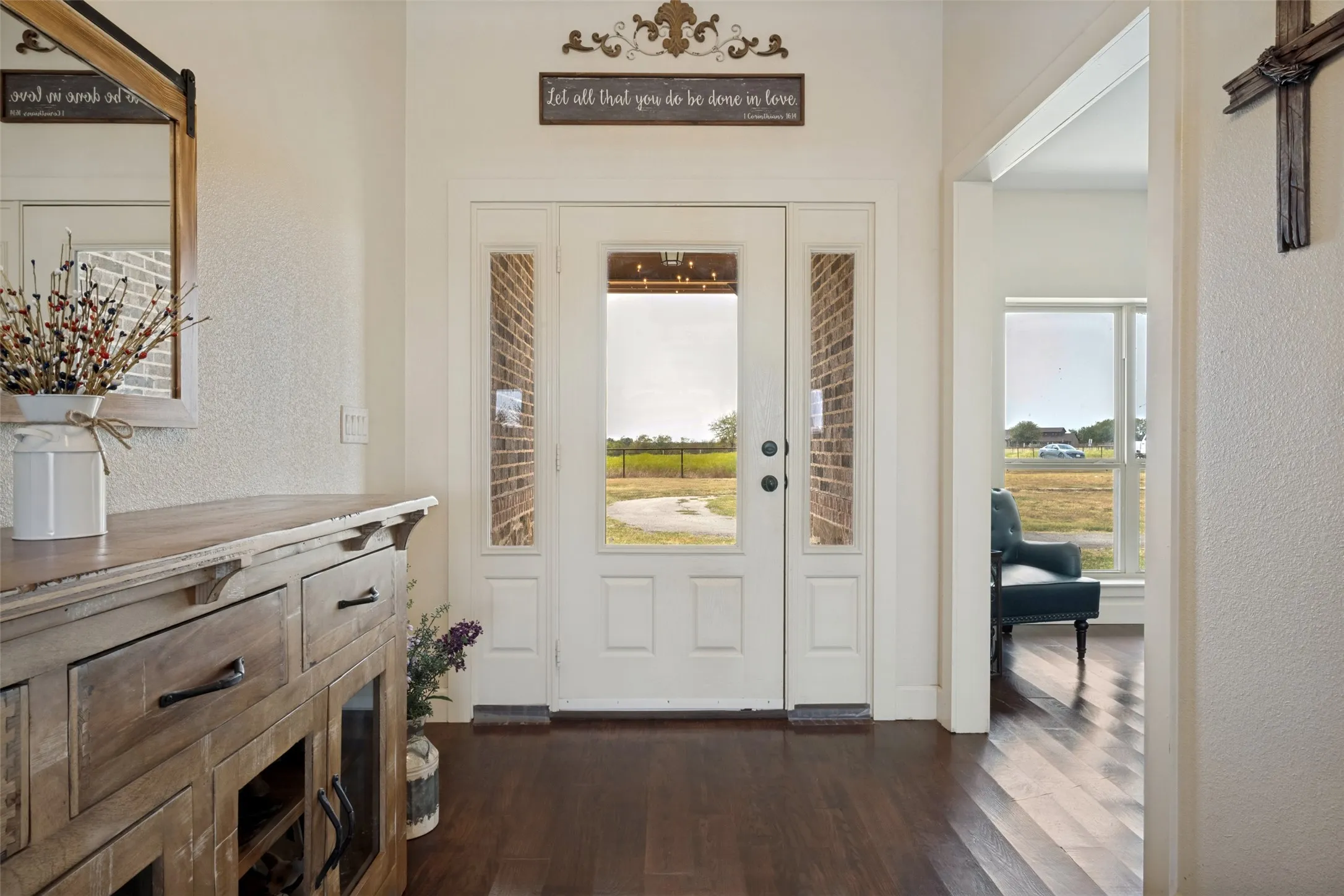 Double entry door with glass sidelights and transom, dark wood-finish flooring, and white painted trim