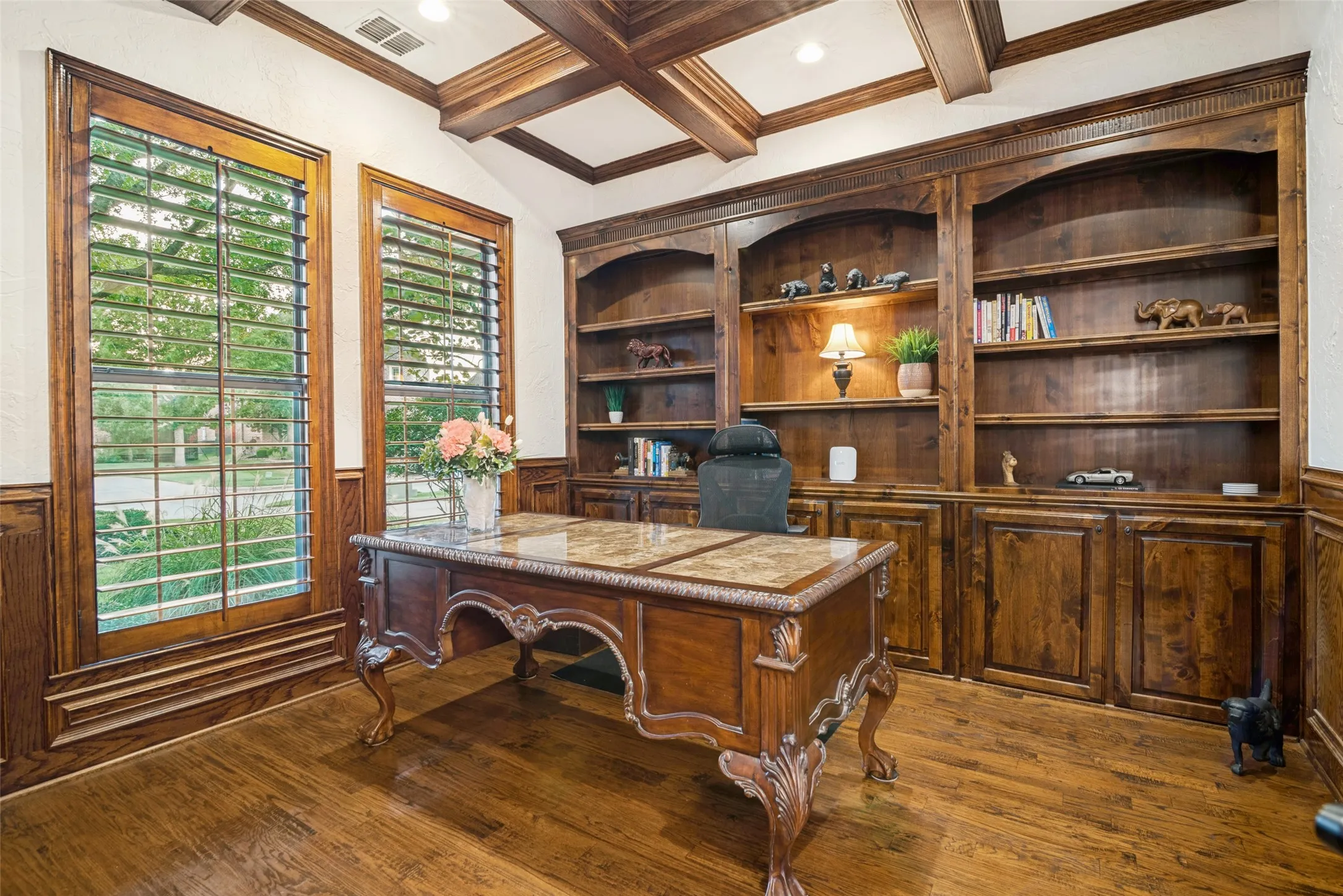 Wood-finish flooring, built-in shelving, wainscoting, and coffered ceiling