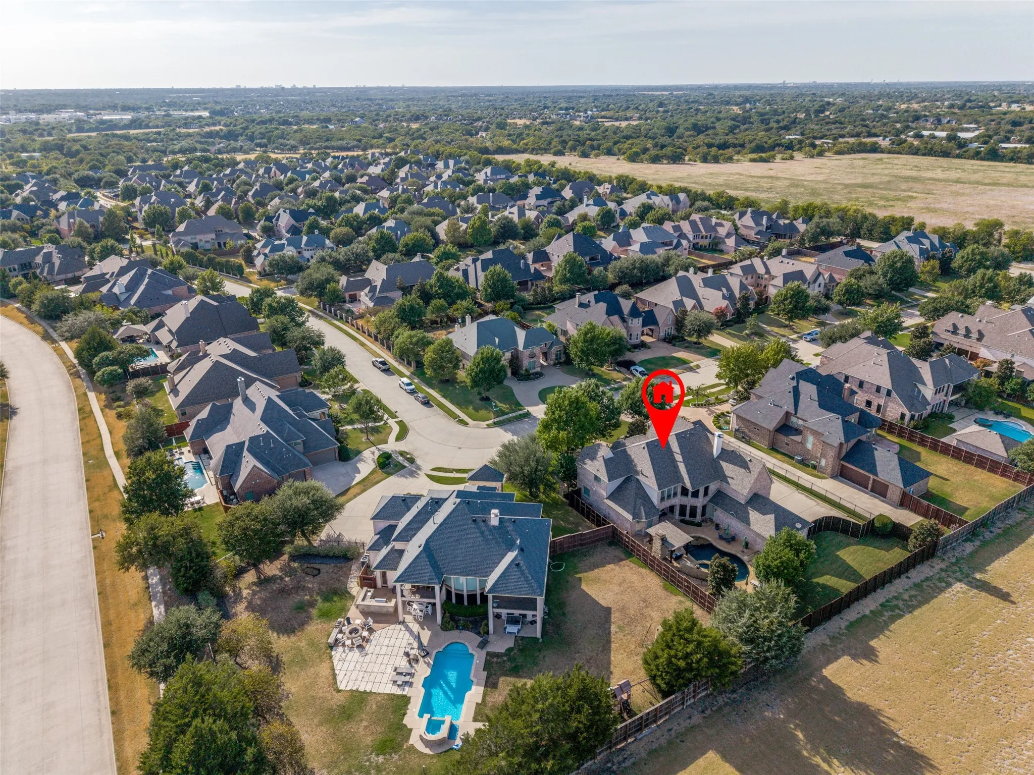 Brick exterior residence with a private backyard pool, fenced perimeter, and established landscaping