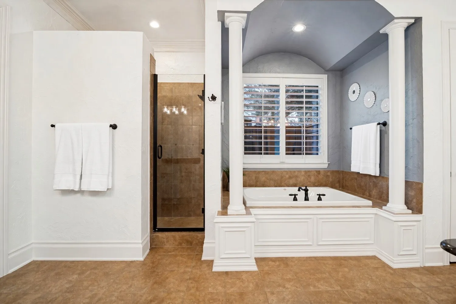 Built-in soaking tub with paneling, enclosed shower with glass door, recessed lighting, and tile flooring
