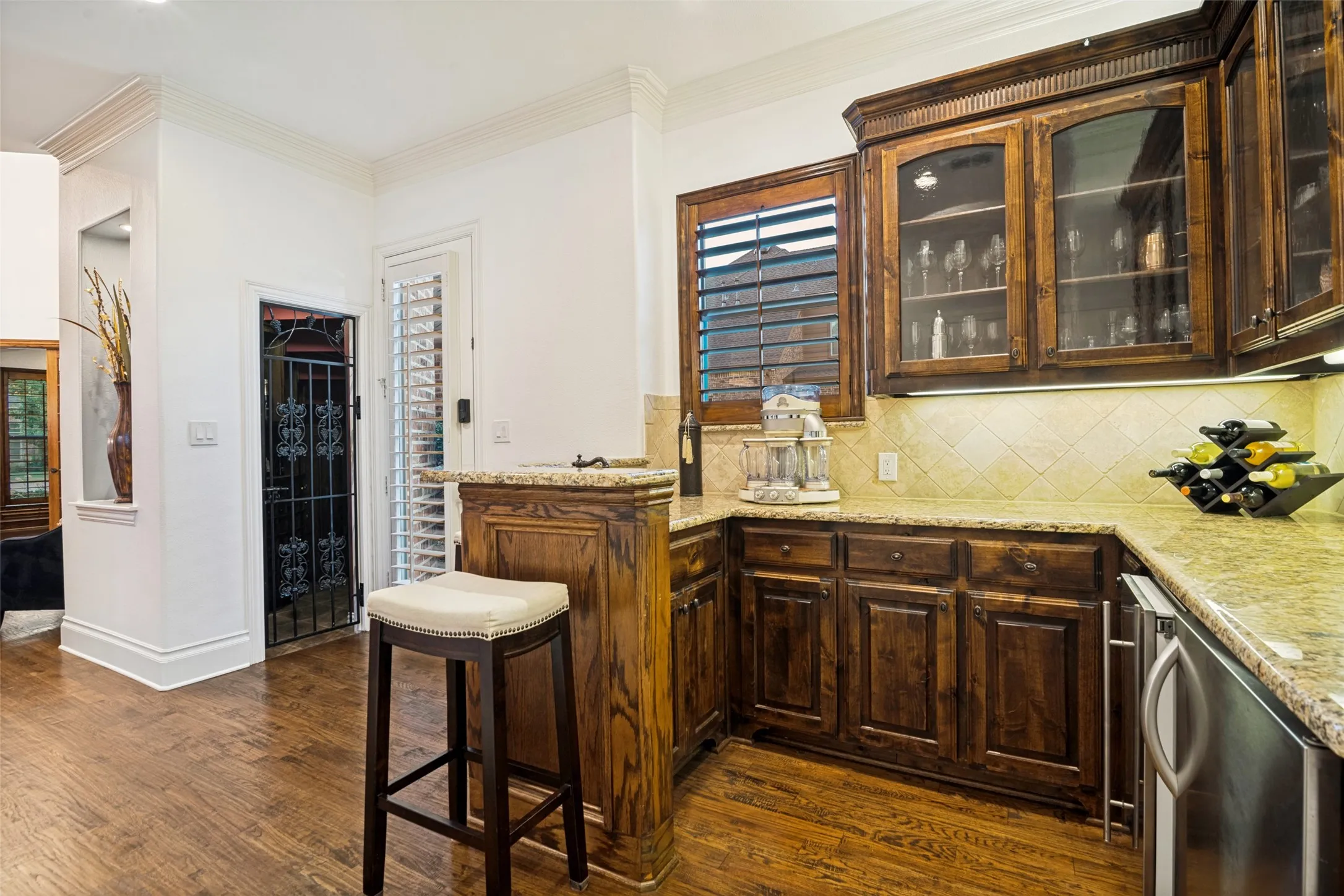 Wet bar leading to wine cellar
