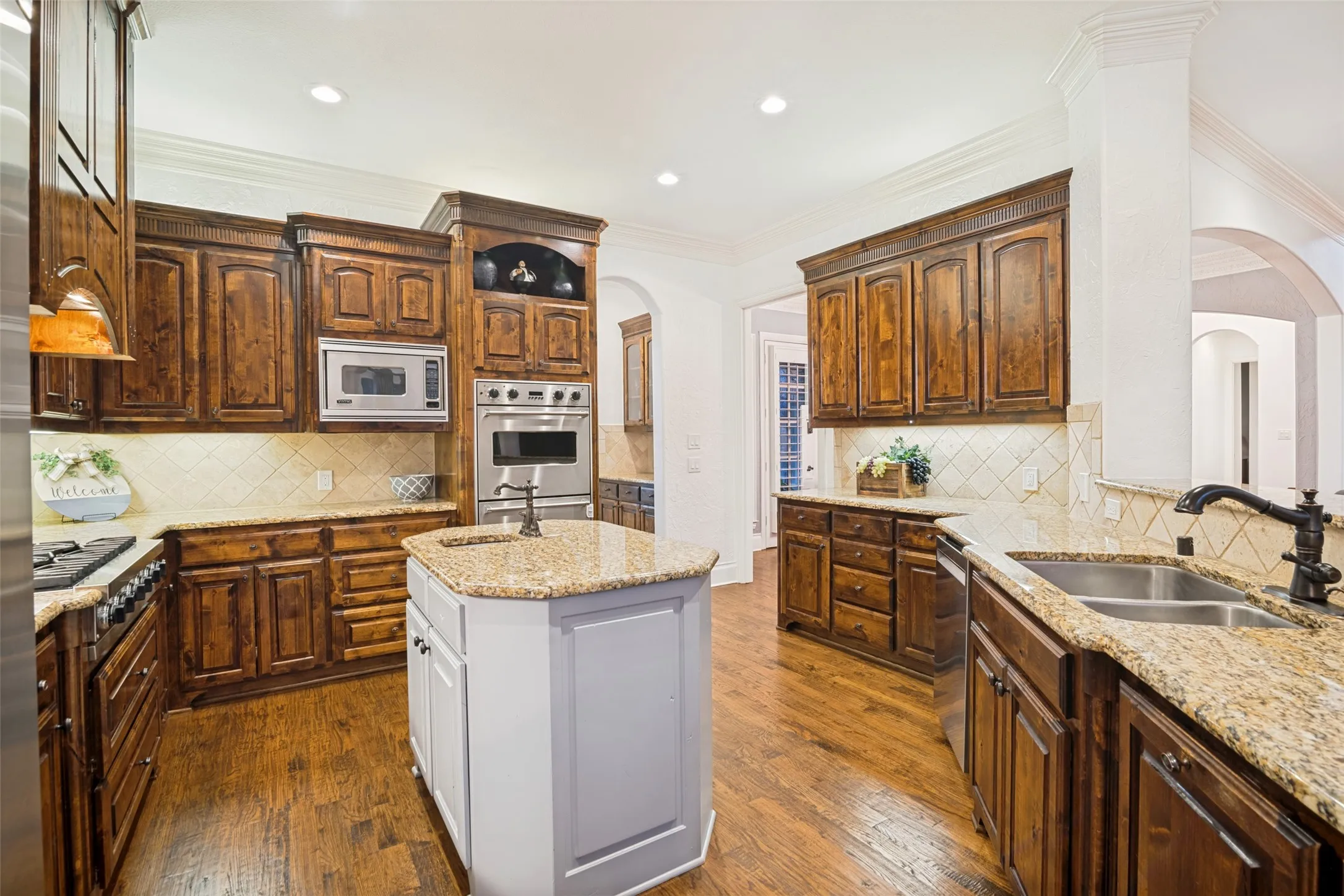 Kitchen featuring wood-finish flooring, recessed lighting, and a center island with Viking appliances and a granite countertop