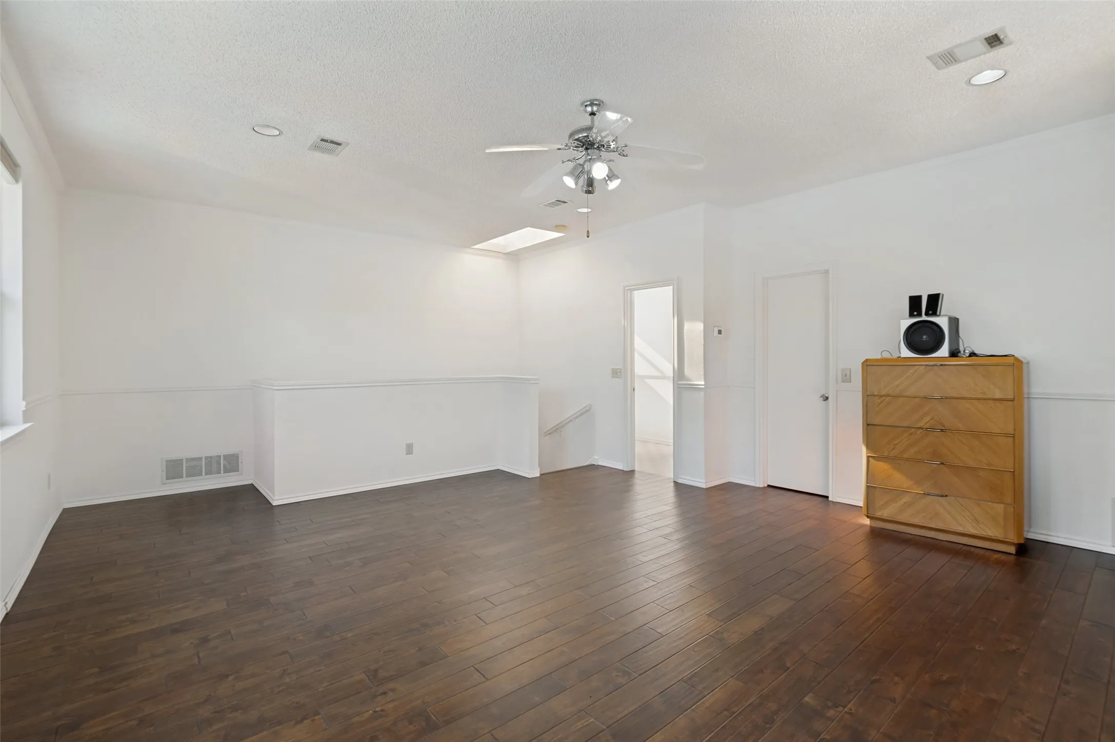 Upstairs room featuring hardwood floors.