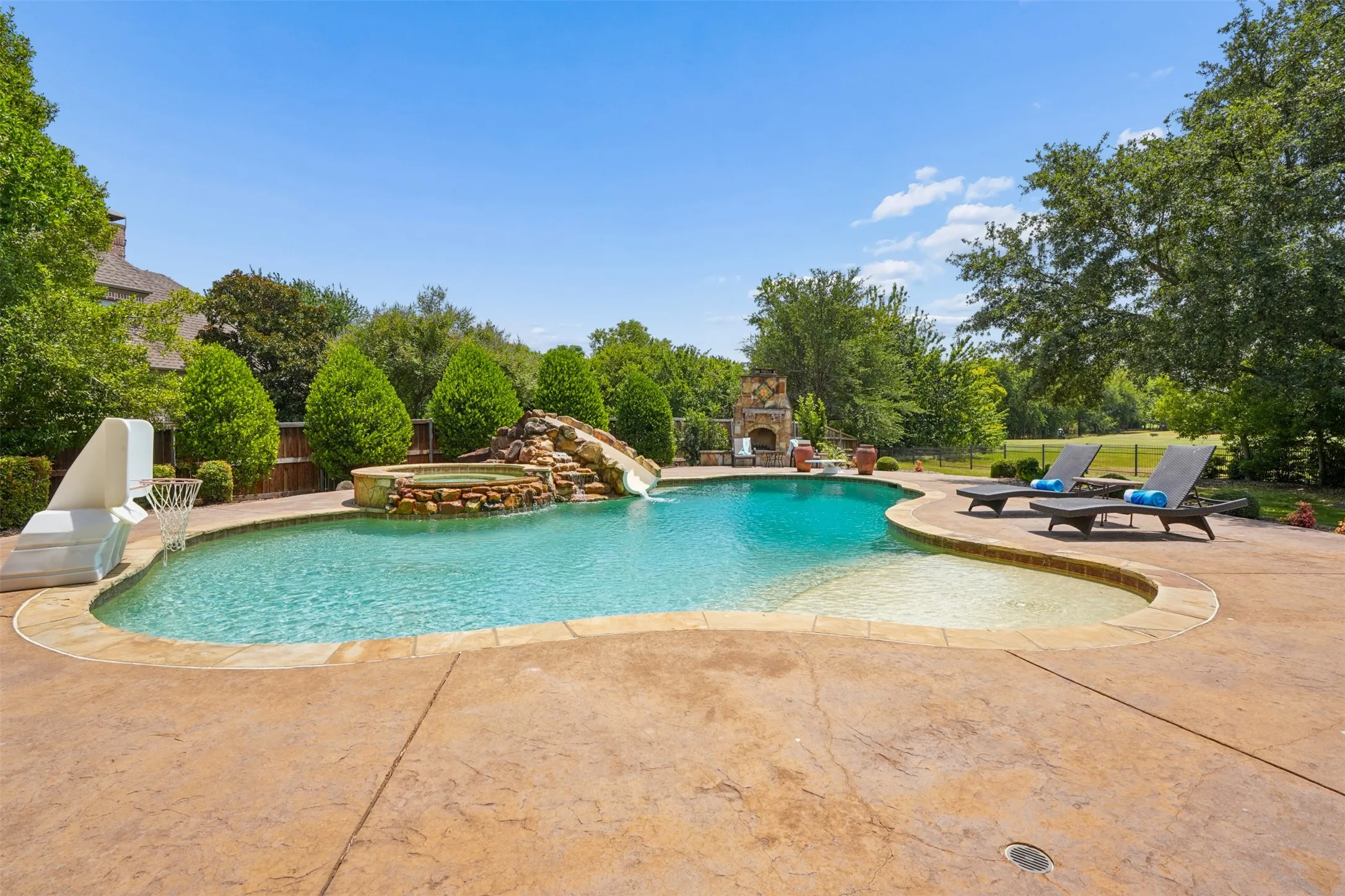 Nine-foot-deep PebbleTec diving pool anchors the resort-style backyard.