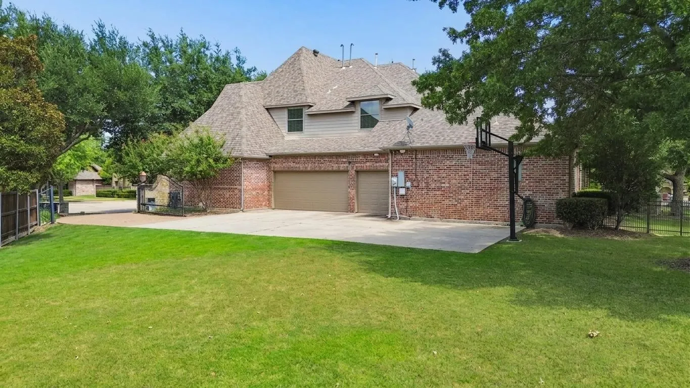 Separate grassy areas provide room for recreation beyond the pool and outdoor entertaining spaces.