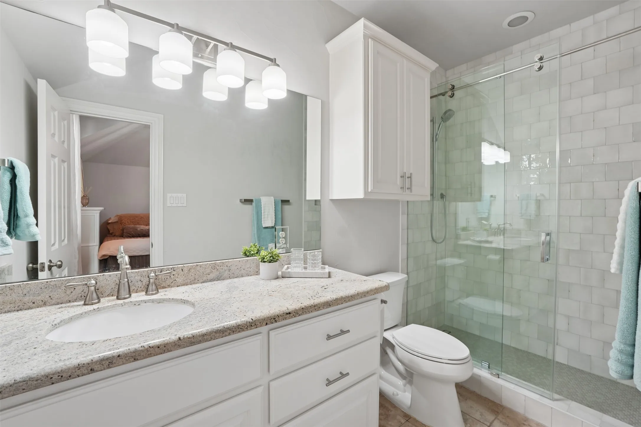 Updated upstairs bathroom features a clean, neutral design and functional vanity space.