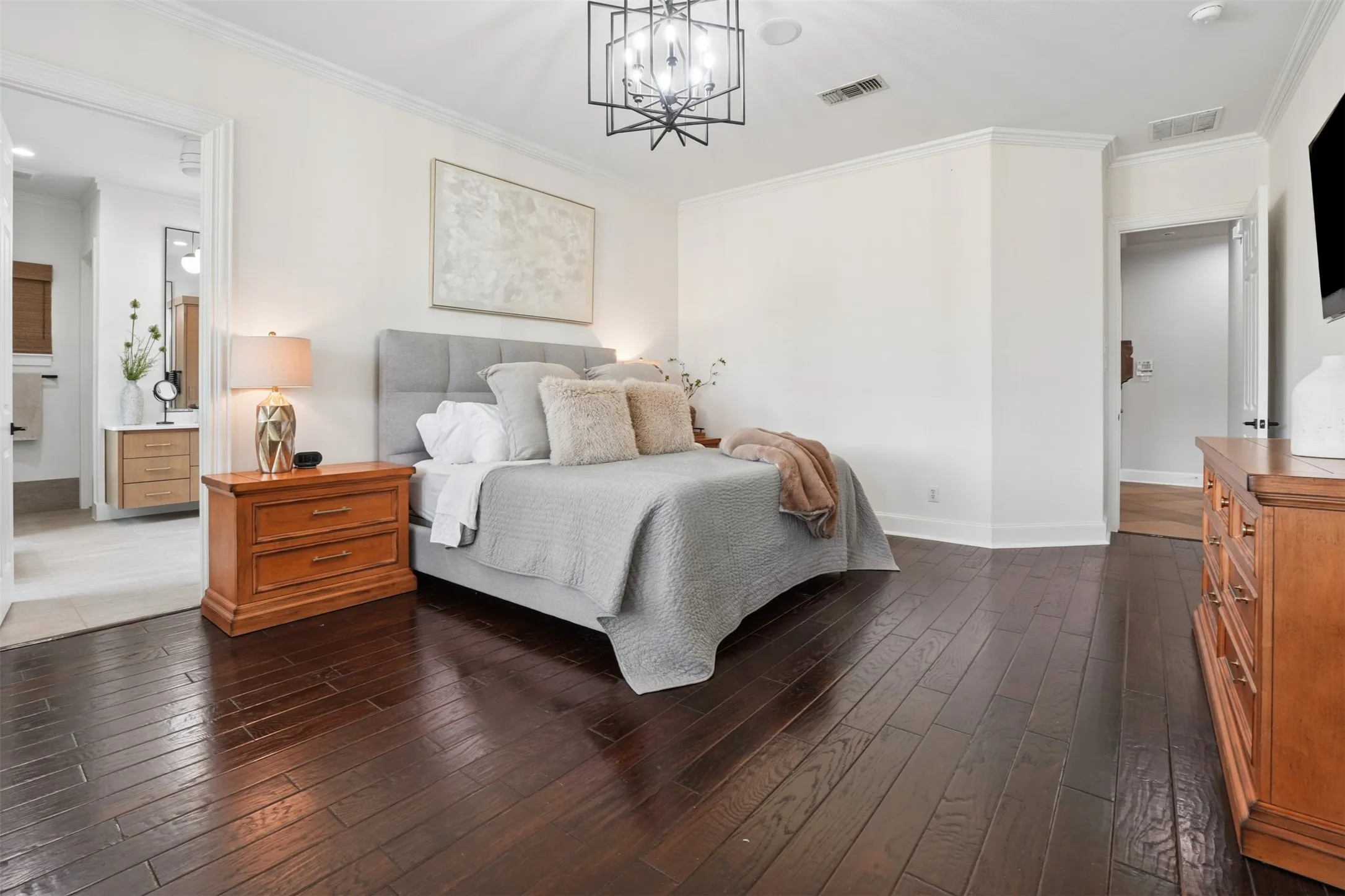 Downstairs primary suite combines privacy, scale and convenient access to the main living level.