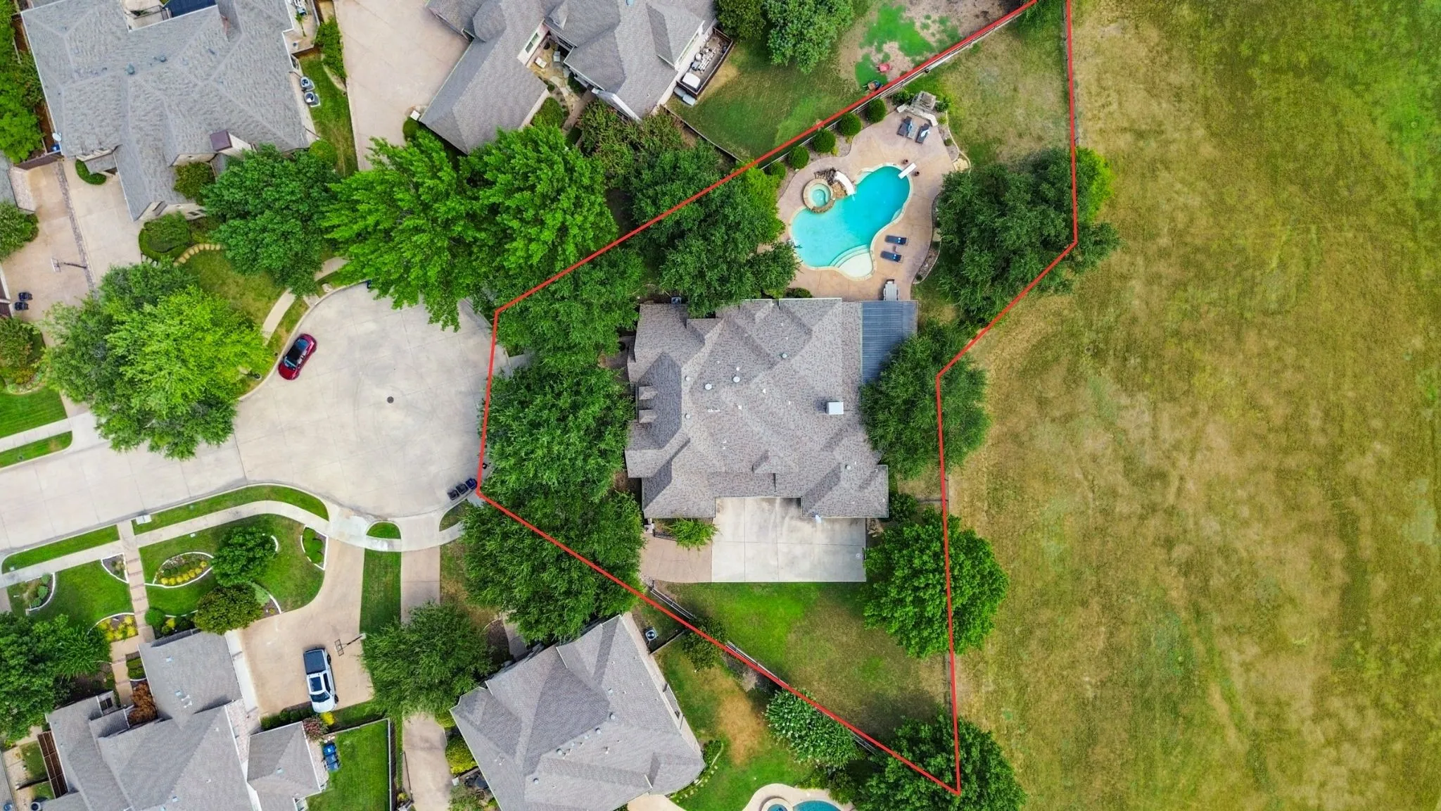 Overhead view shows the home's substantial footprint and outdoor spaces across the 1/2 acre lot.