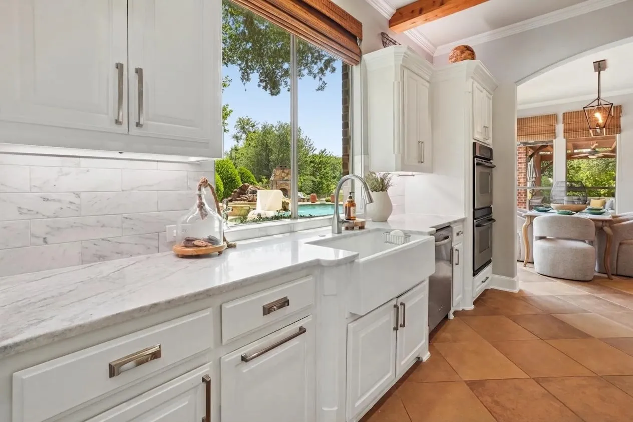 Custom hardware, a porcelain farmhouse sink and a kitchen window view that makes you smile.