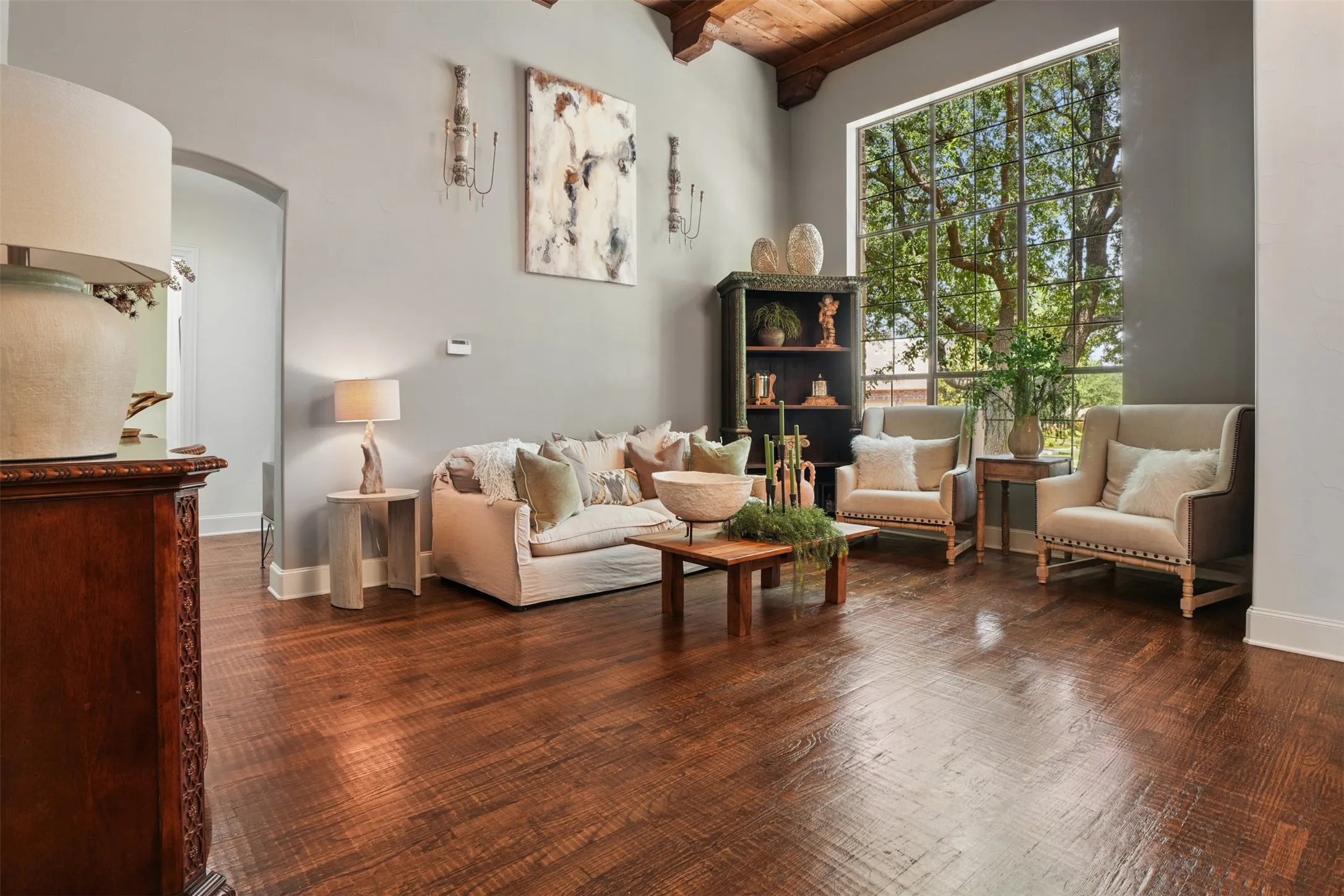 Formal living room features a distinctive wood-lined ceiling, rich millwork and picture window views of the front yard.

