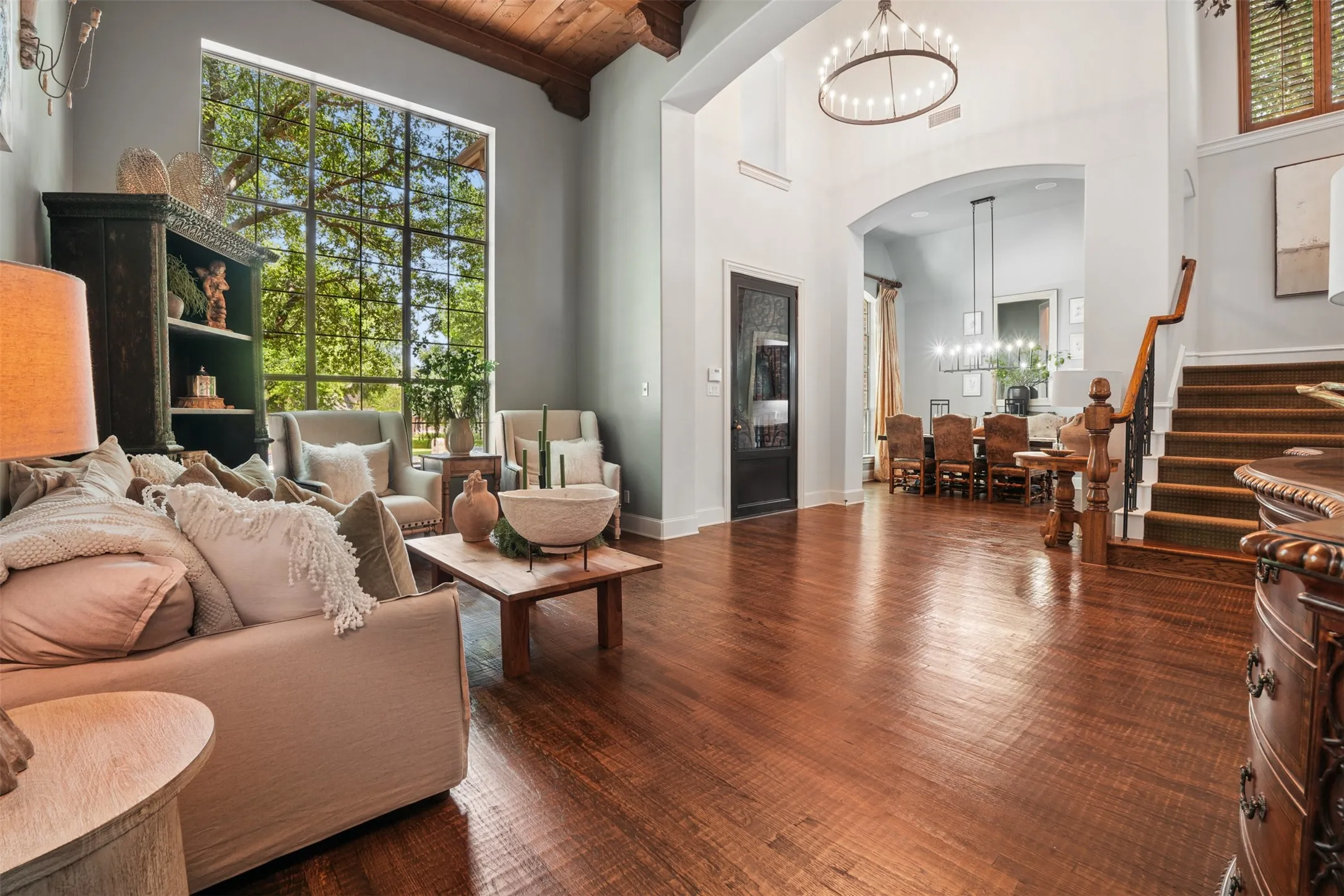 Dramatic entry introduces soaring ceilings, hand-scraped hardwood floors and custom architectural detail.